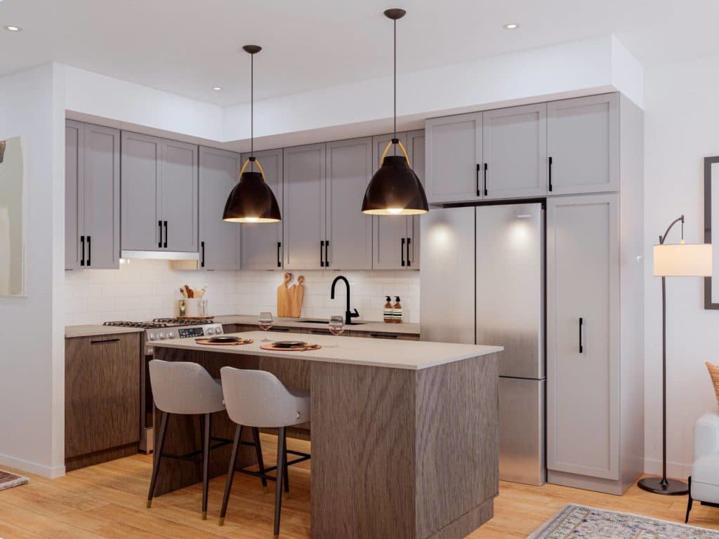 Aldergrove Town Centre – Rendering of a kitchen with gray cabinetry, dark dome pendant lights, a stainless refrigerator, and a center island with bar stools.