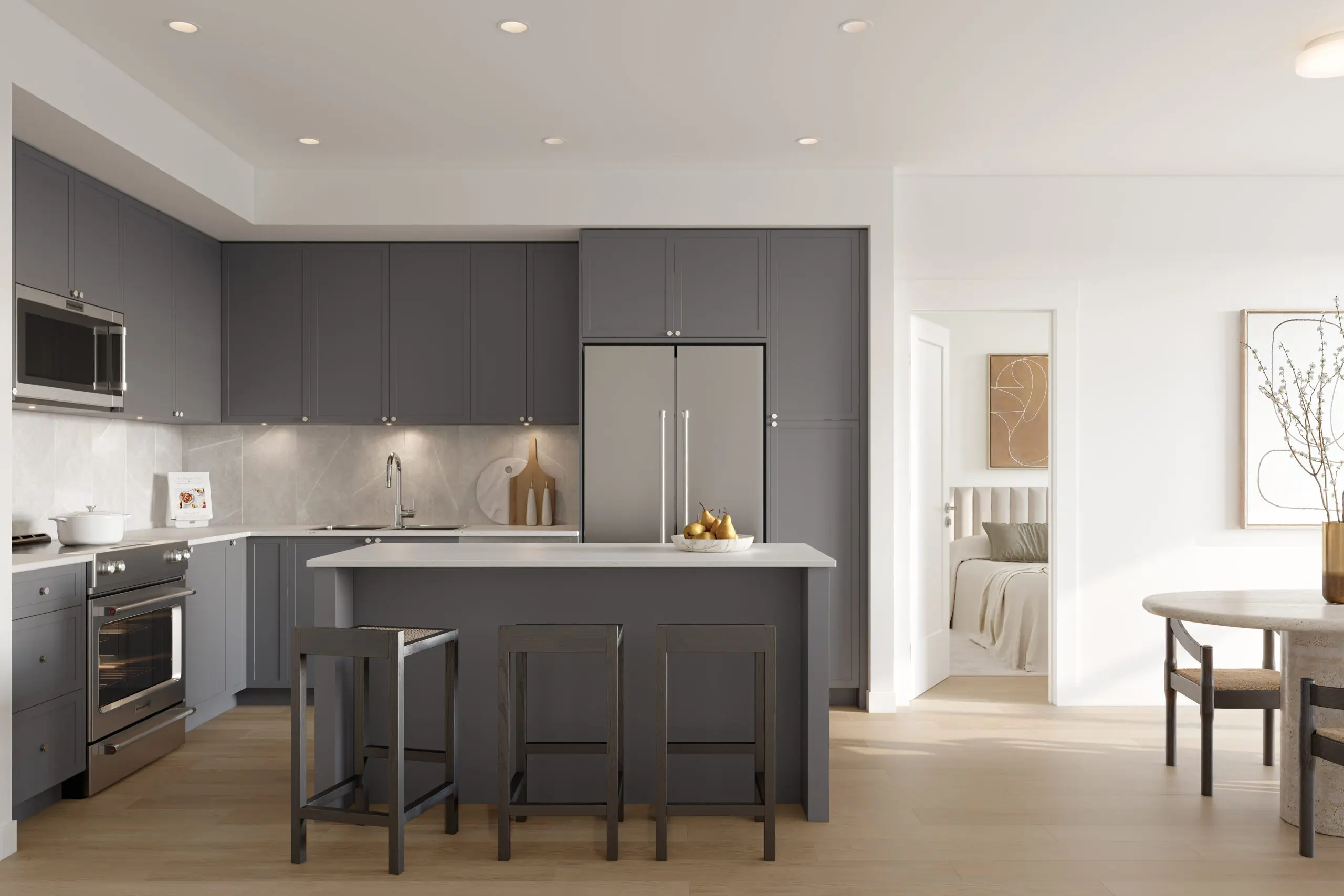 Fleetwood Village 2 – Kitchen with dark gray cabinetry, stainless fridge and oven, white countertops, an island with three stools, opening to a bedroom and dining nook.