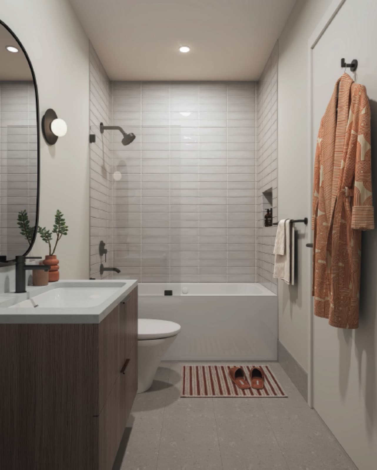 Soul – Bathroom with a tub-shower combination, subway tile walls, a wood vanity, and a robe hanging on the door.