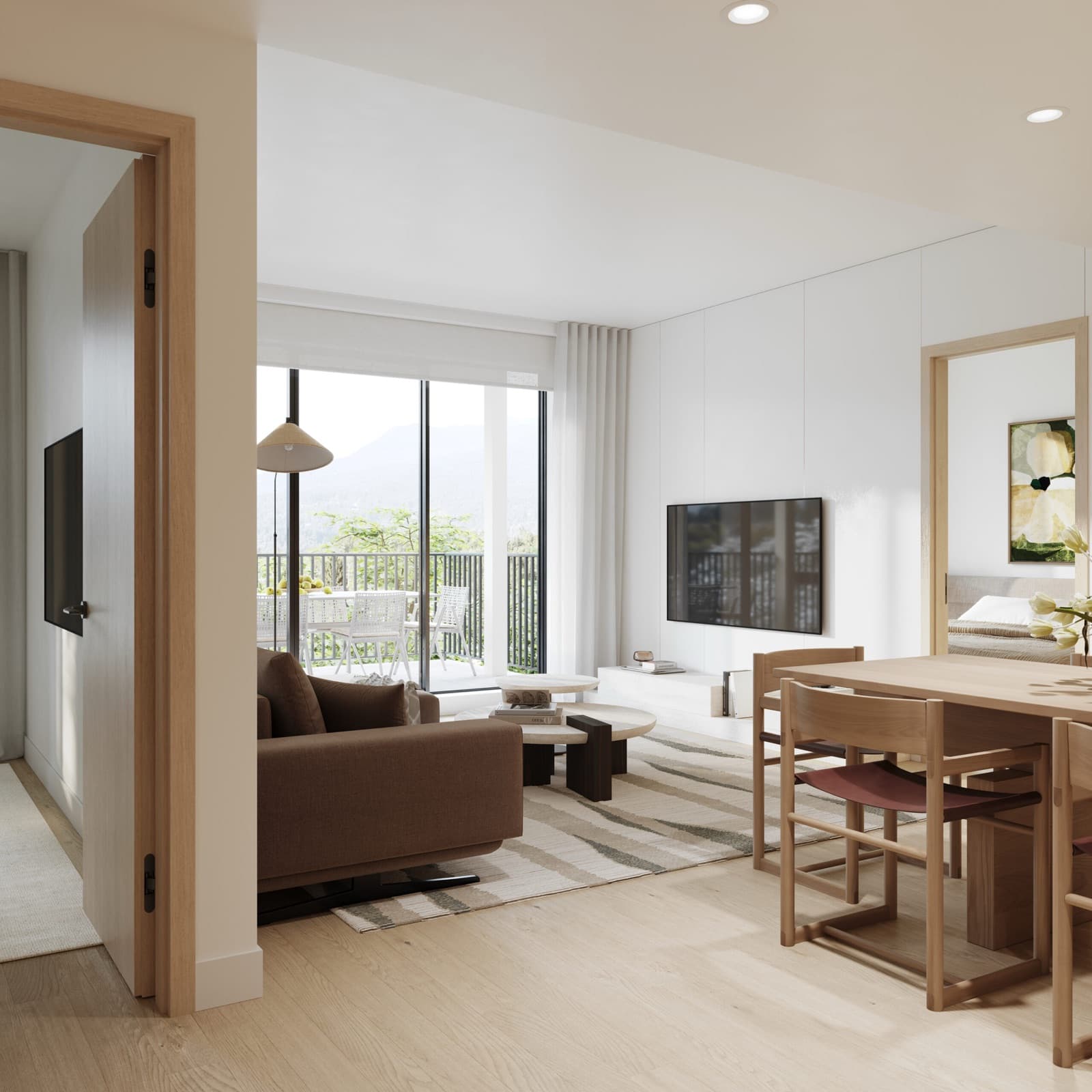 Siena – An open-concept living and dining area with a brown sofa, round nesting coffee tables, a wall-mounted TV, and a wood dining table, with a balcony and mountain view beyond the sliding glass doors.