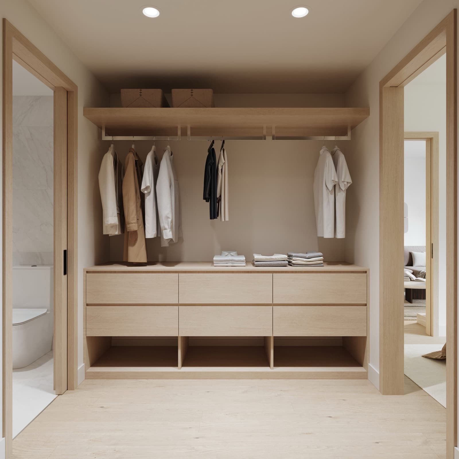 Siena – A walk-in closet with open hanging rods holding shirts and jackets, folded clothes on a wood dresser with drawers, and a bathroom with a soaker tub visible through a door on the left.