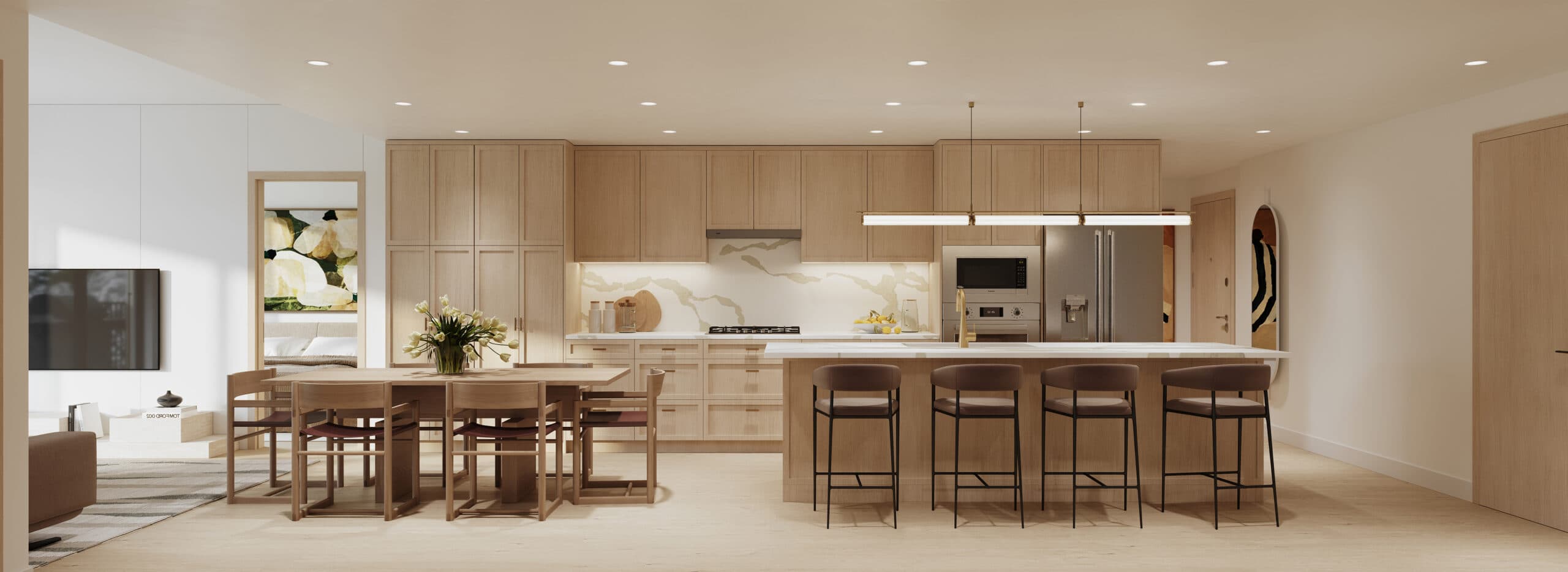 Siena – A wide panorama of an open kitchen with light wood cabinetry, a marble-look backsplash, stainless steel refrigerator and microwave, a long island with brown bar stools, and a wood dining table.