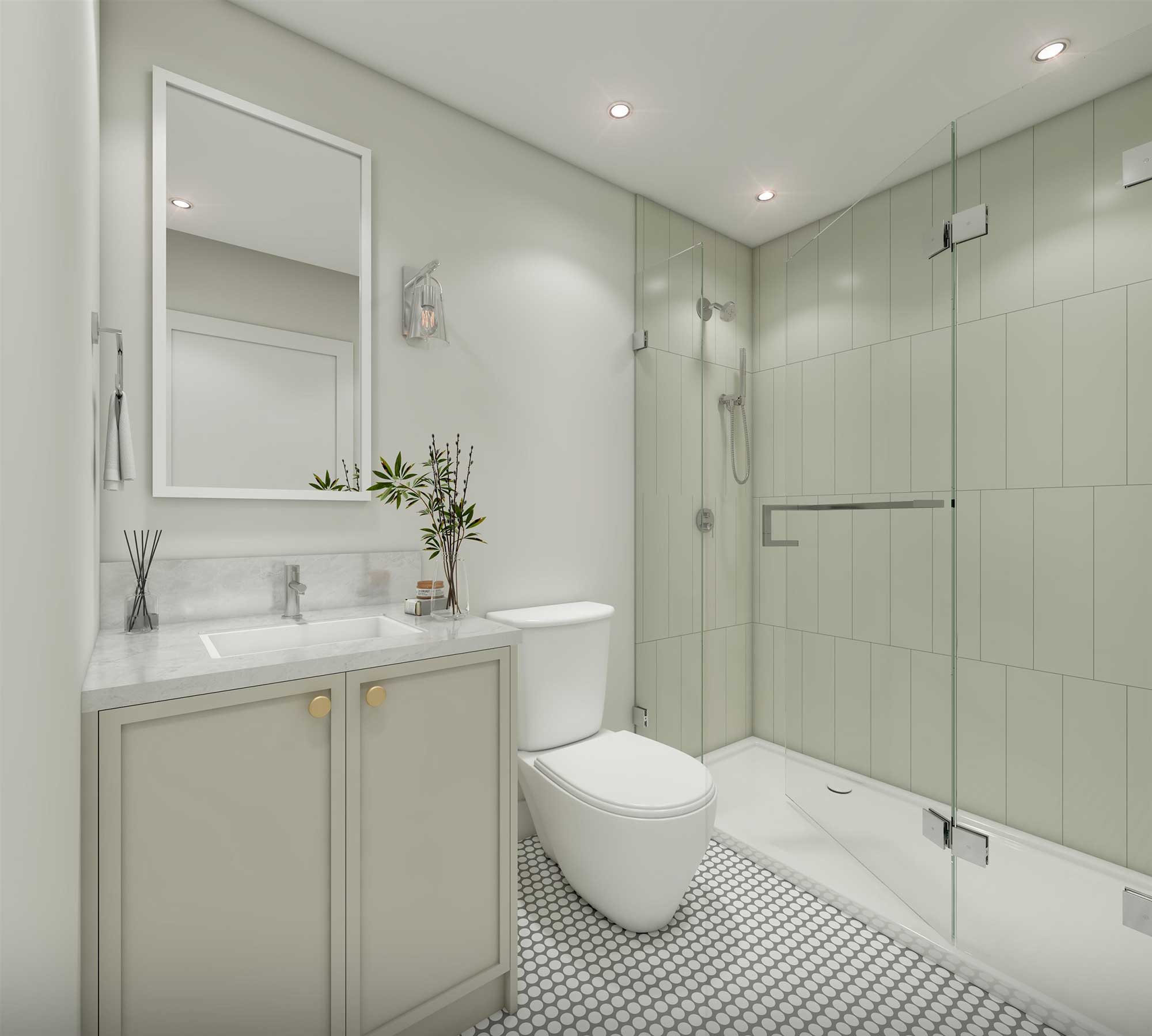 Water Tower Hill – A modern bathroom featuring a walk-in glass shower lined with pale green vertical tiles and a white mosaic penny-tile floor. A light grey vanity with brass knobs, a marble countertop, and a matching framed rectangular mirror stands alongside the toilet under recessed ceiling lighting.