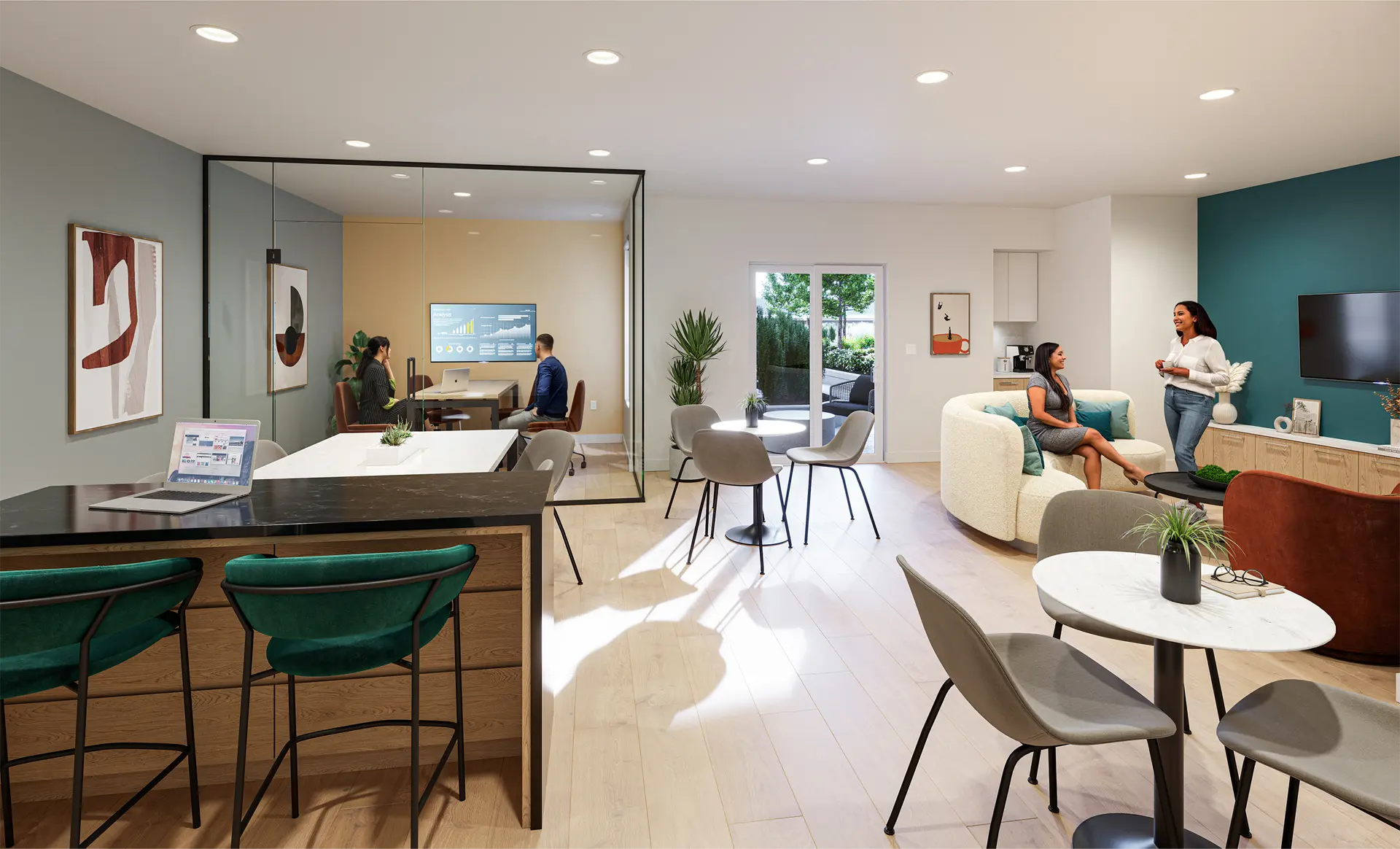 Jethro – Shared coworking and social lounge with a glass-walled meeting room, a communal work table, cafe seating, and a kitchenette with residents socializing.