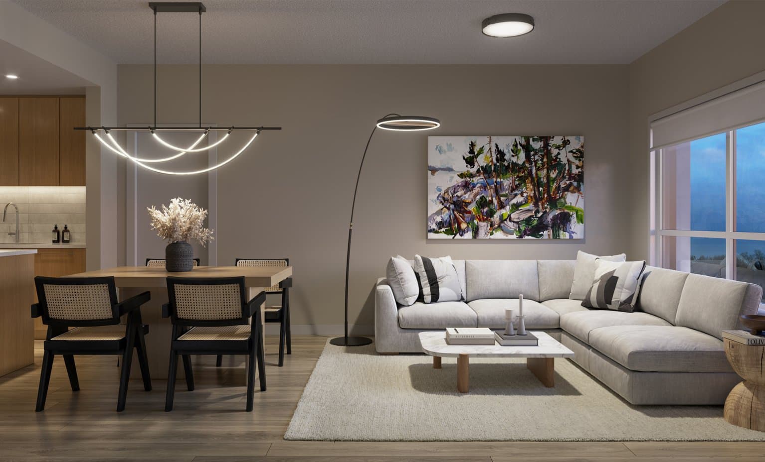 Lennox – Living and dining area at dusk with a sectional sofa, large abstract painting, and dining table with cane chairs.