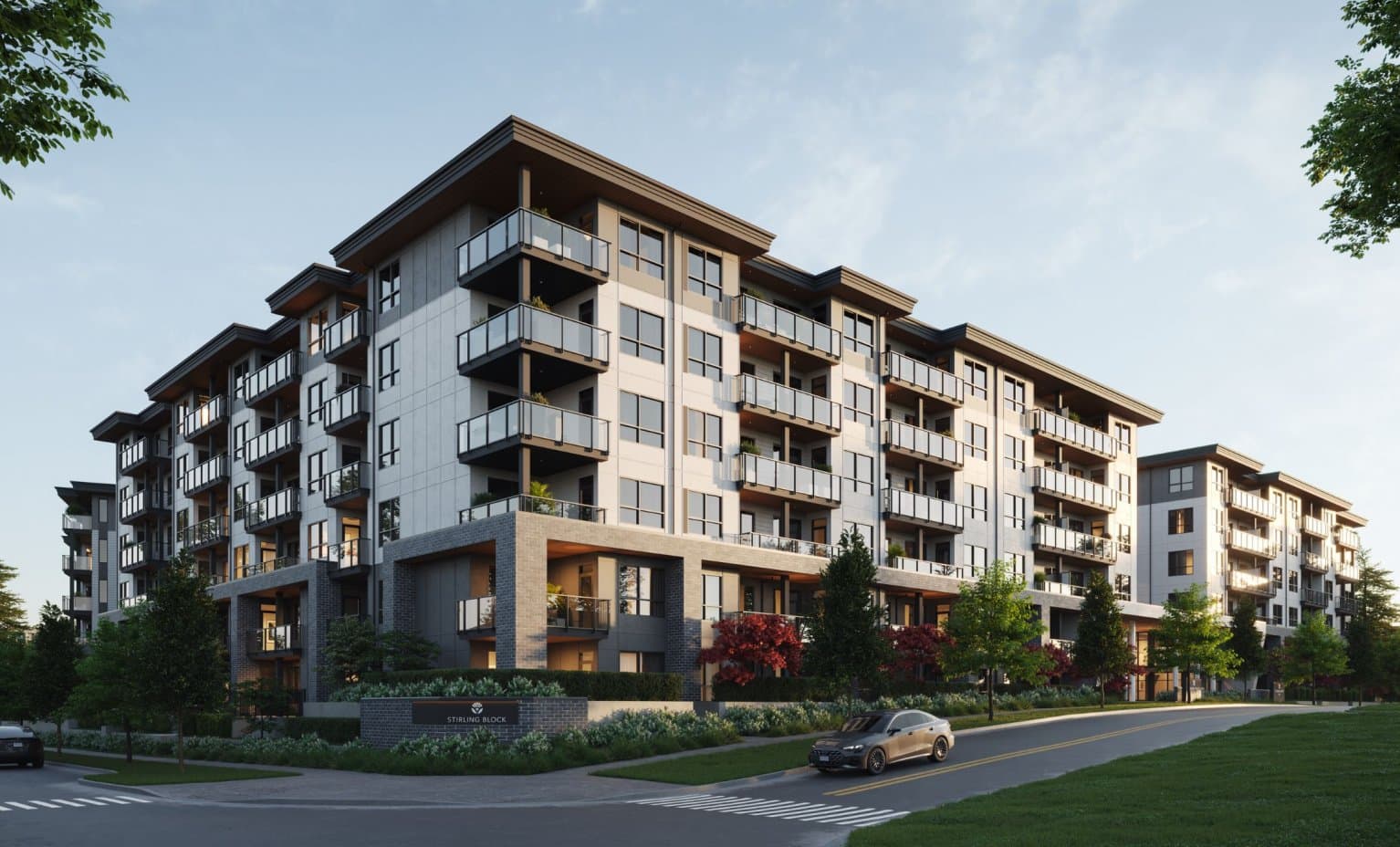 Stirling Block – Angled street-level rendering of the same Stirling Block condo building showing its wrap-around facade, ground-floor entries, and a sign reading 'Stirling Block' on the front lawn.