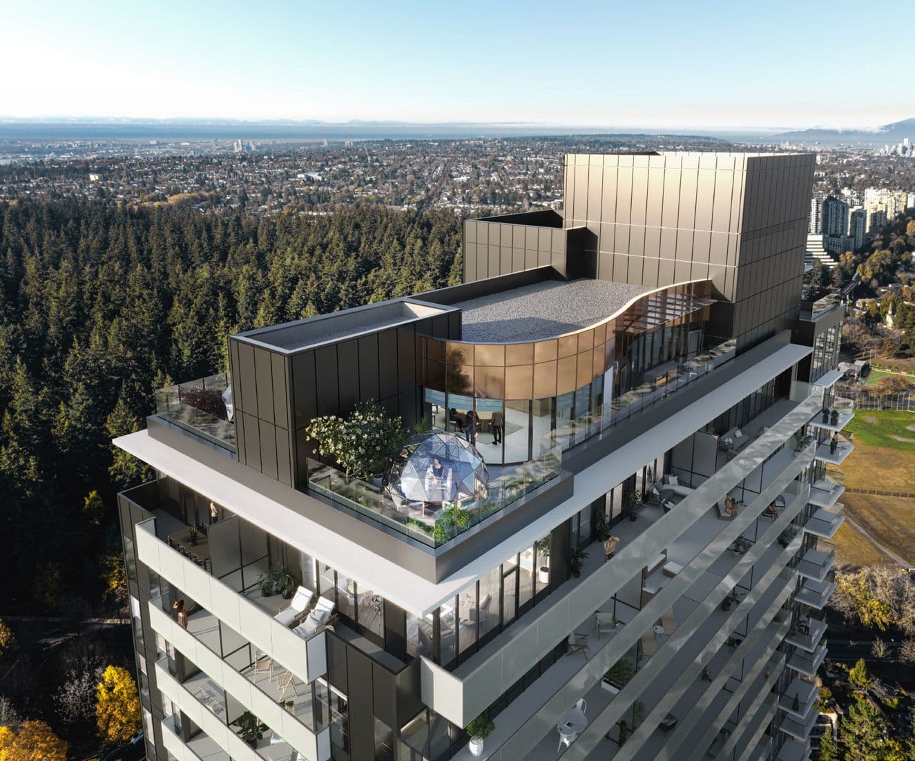 Perla Condos – An aerial drone view of the top of the tower showing a rooftop amenity deck with a glass dome and lounge furniture, overlooking forest and city below.