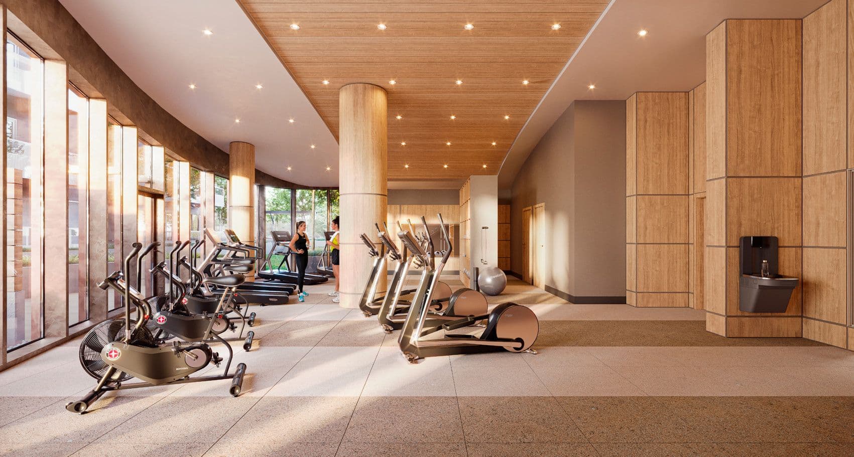 Perla Condos – A building fitness center with rows of cardio machines, wood paneled columns, floor-to-ceiling windows, and two people using treadmills.
