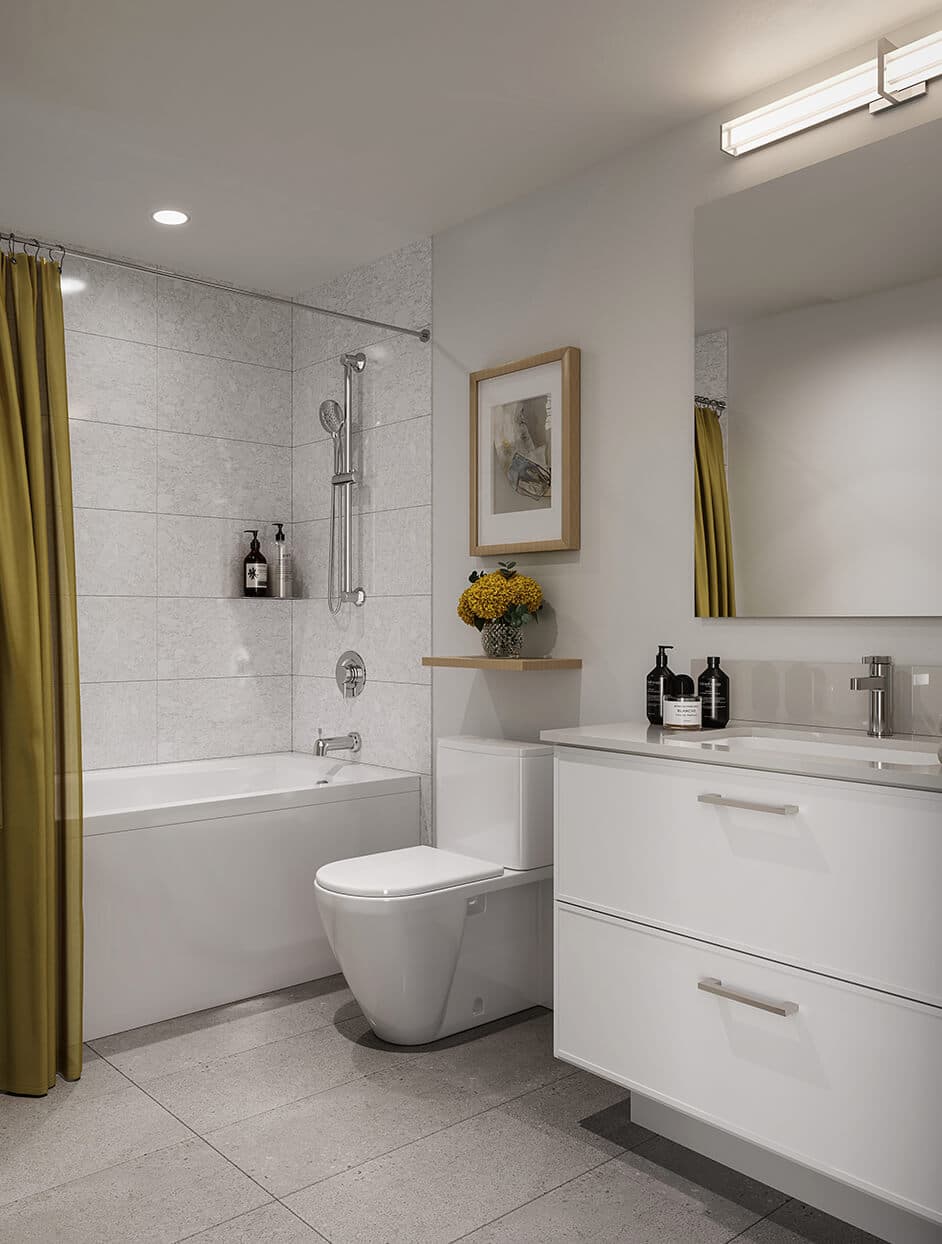Kestrel – Bathroom with a soaking tub, mustard-yellow shower curtain, white vanity with two drawers and framed art above the toilet.