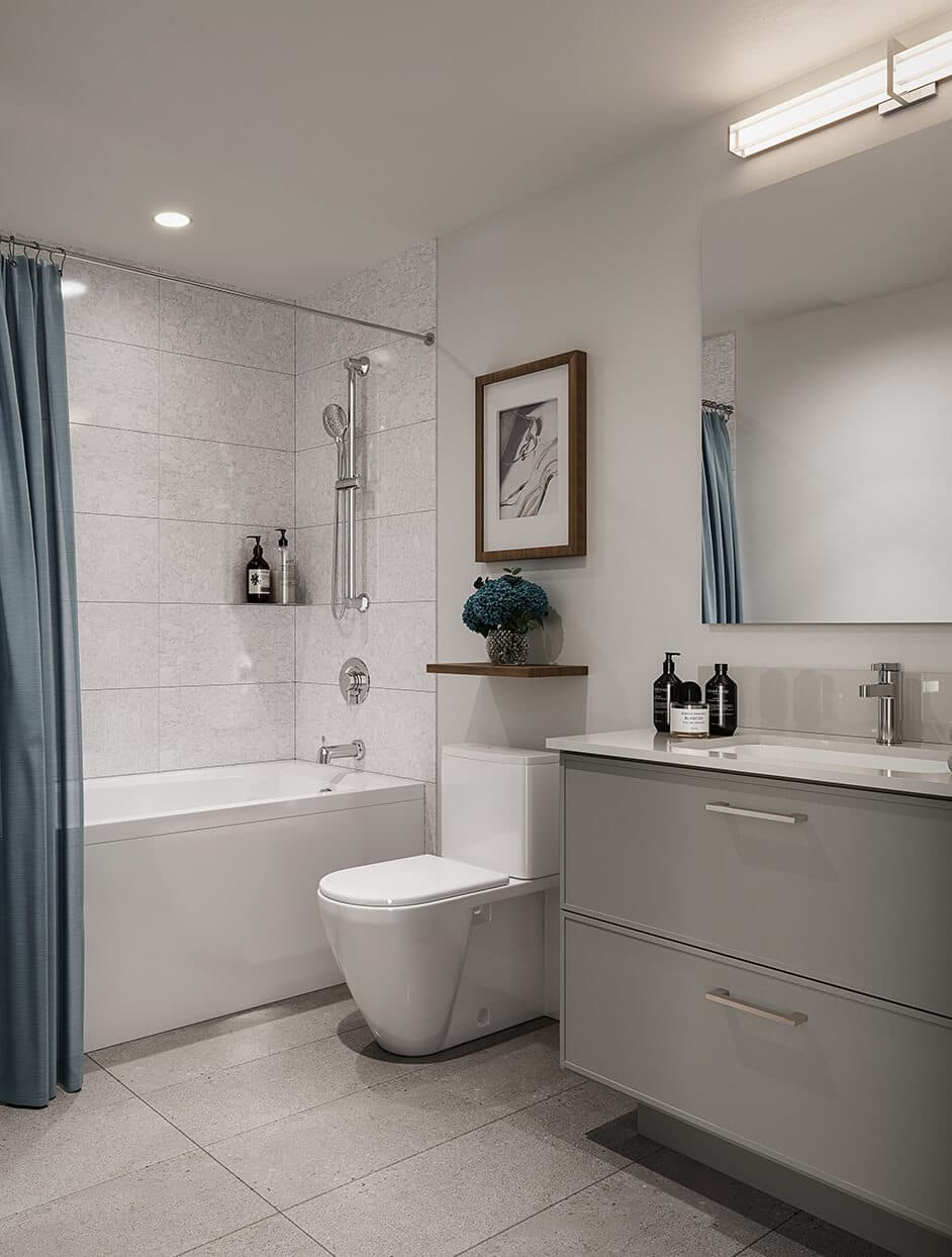 Kestrel – Bathroom with a soaking tub, light blue shower curtain, and a gray two-drawer vanity, same layout as the other bathroom photo in a different color scheme.