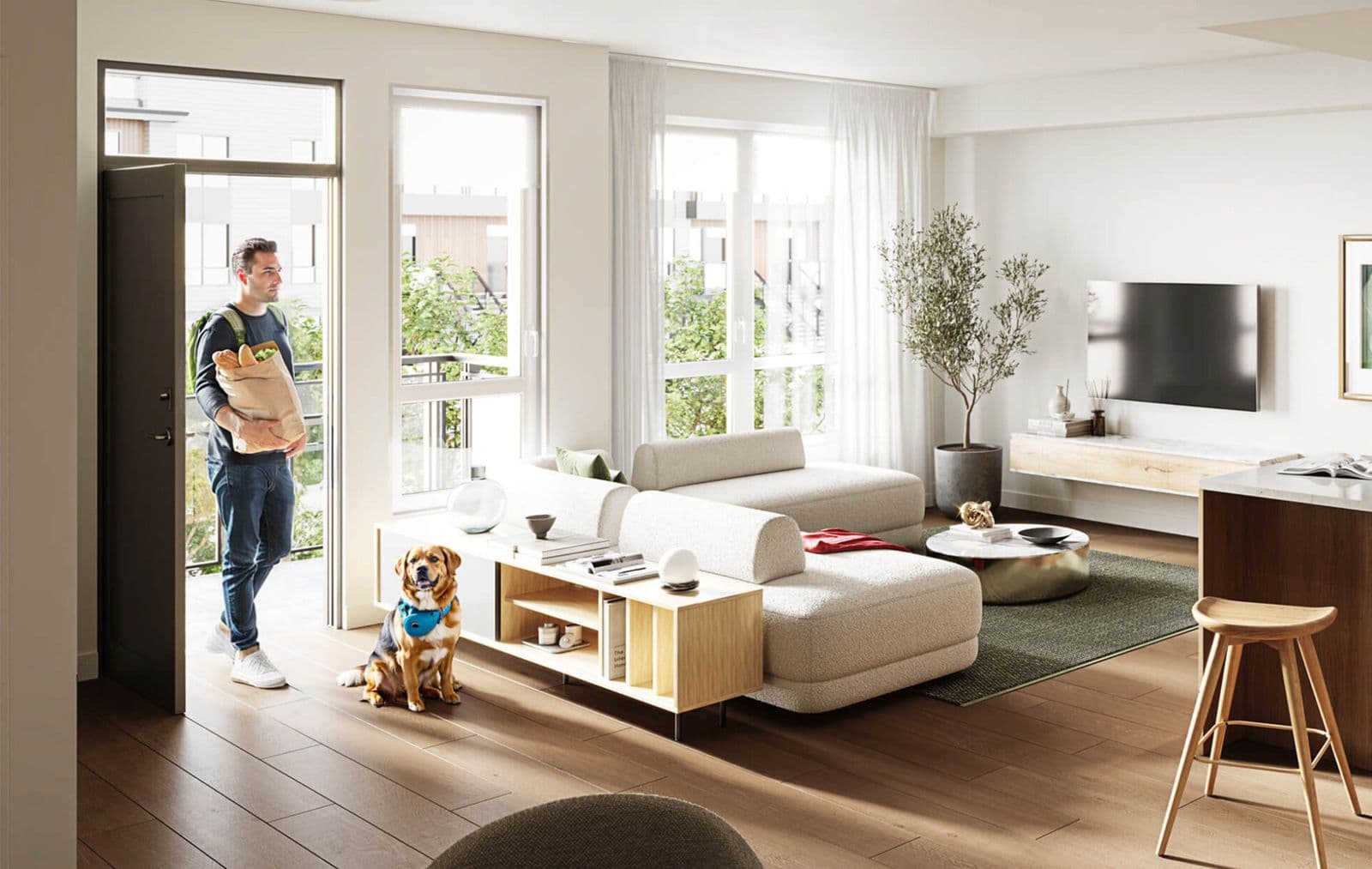 Kestrel – Living room with a man holding groceries and a dog by the sofa near an open balcony door, similar staging to the other living room shots.