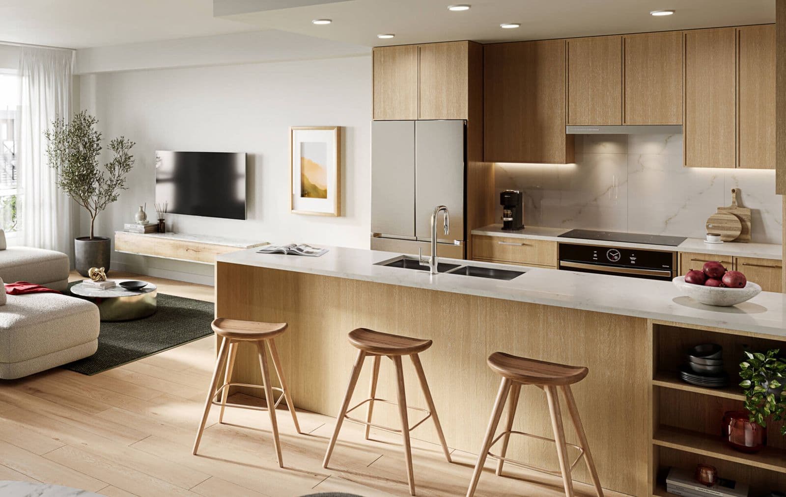 Kestrel – Kitchen with light wood cabinetry, stainless fridge, marble-look backsplash and island with wood bar stools, living room visible in the background.