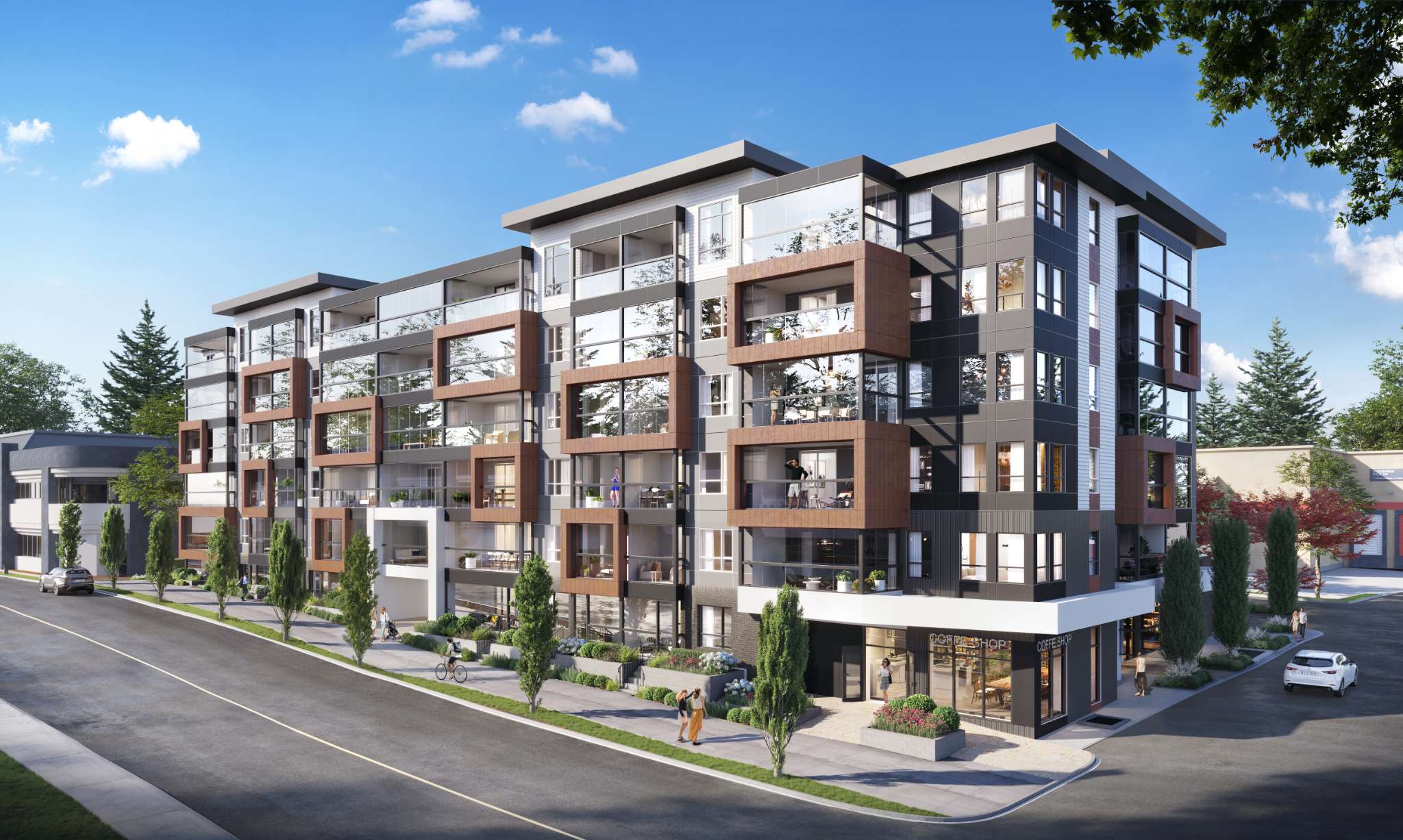 Auburn – Street-level daytime view of the condo building's corner, with a ground-floor coffee shop and pedestrians on the sidewalk.