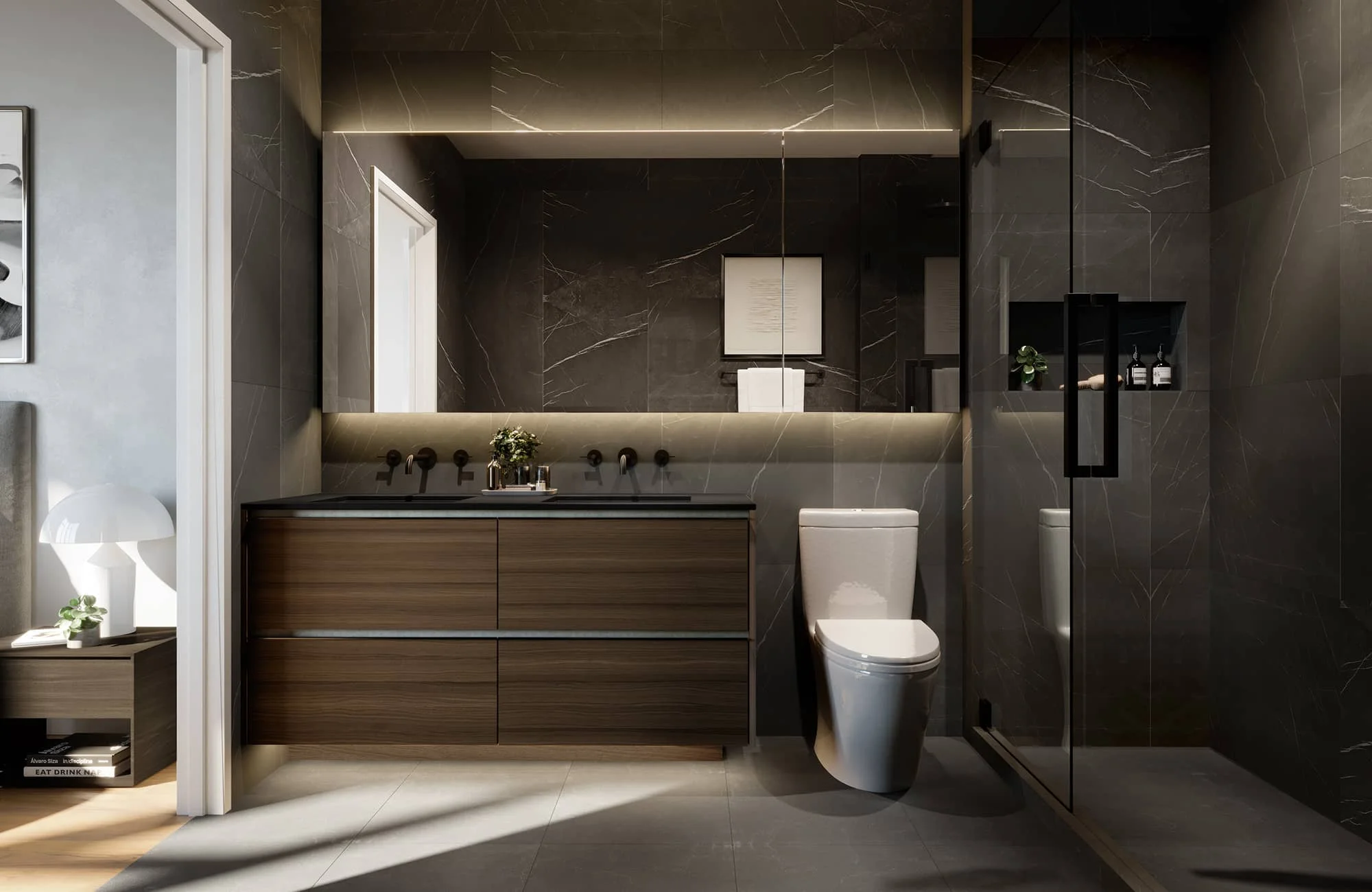 W16 by Olson Kundig – A modern luxury bathroom featuring dark marble tiled walls, a dark wood floating double vanity, and a large illuminated mirror. To the right stands a white toilet next to a glass-enclosed walk-in shower, creating a sophisticated and moody atmosphere.