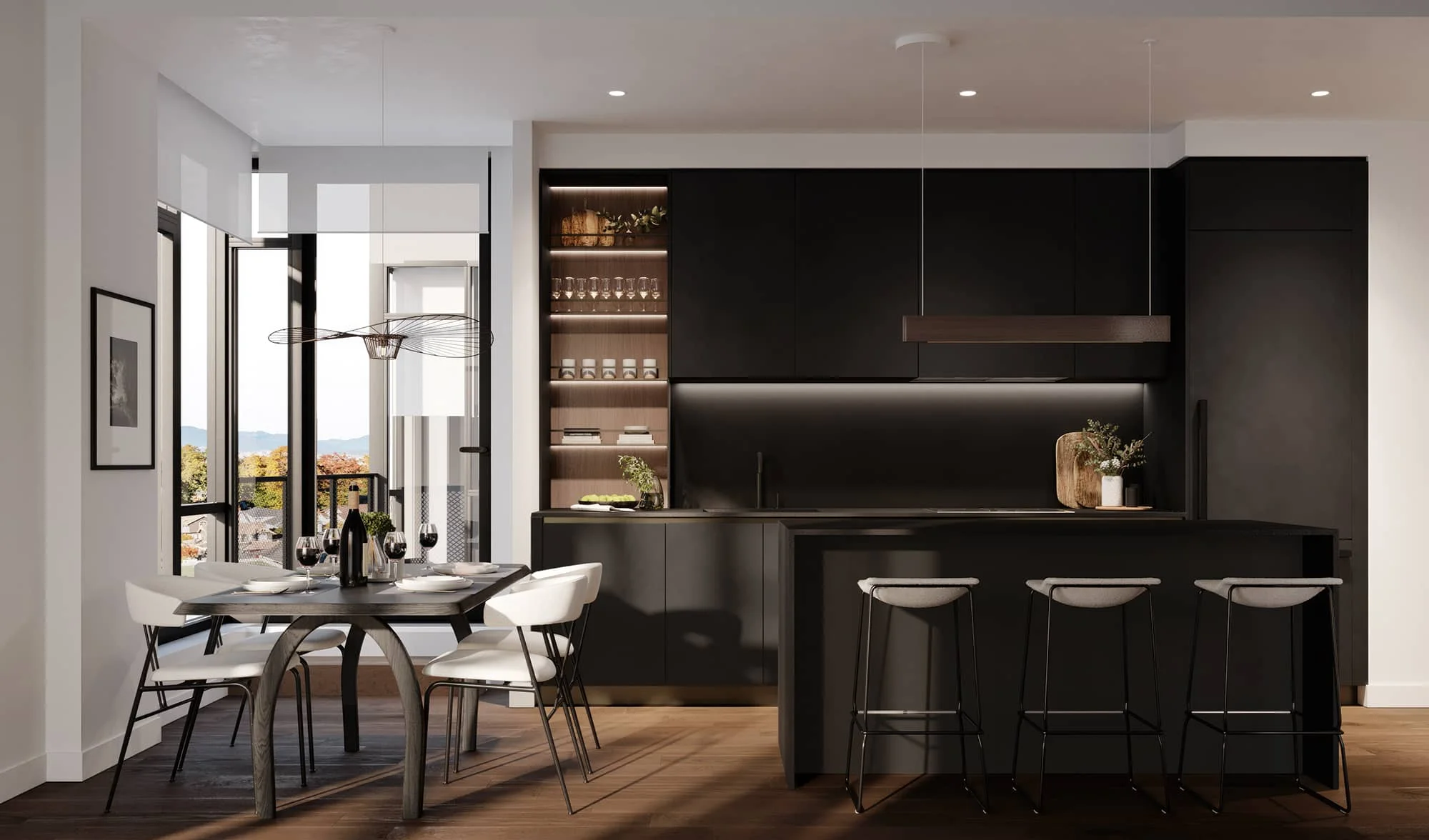 W16 by Olson Kundig – A modern open-concept kitchen and dining area featuring sleek matte black cabinetry, integrated under-shelf lighting, and a dark island with three bar stools. Adjoining the kitchen is a dining setup with a dark wood table and white contemporary chairs, positioned beside floor-to-ceiling windows that overlook autumn trees and distant mountains.