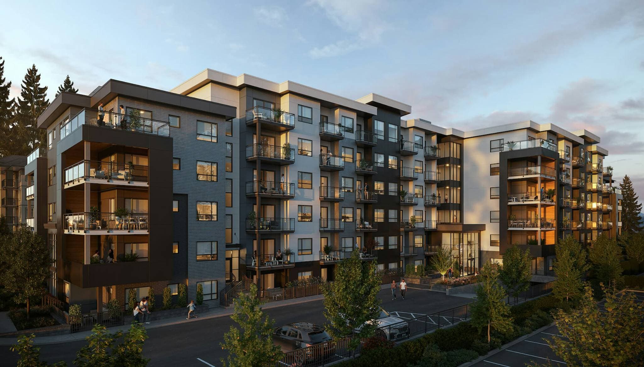 Jacob – Twilight rendering of a mid-rise condo building with dark and light siding, wood-accented balconies, and a landscaped courtyard entrance with pedestrians.
