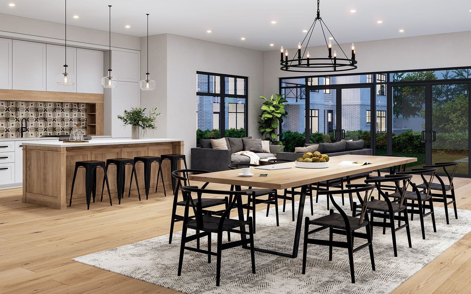 Southaven – Open-concept dining and living area with a long wood table, black wishbone chairs, a chandelier, and a kitchen with patterned tile backsplash in the background.