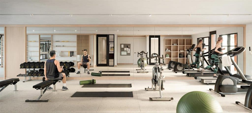 The Oaks Phase 3 (Willow) – A fitness room with treadmills, ellipticals, free weights, a spin bike, and mirrored walls.