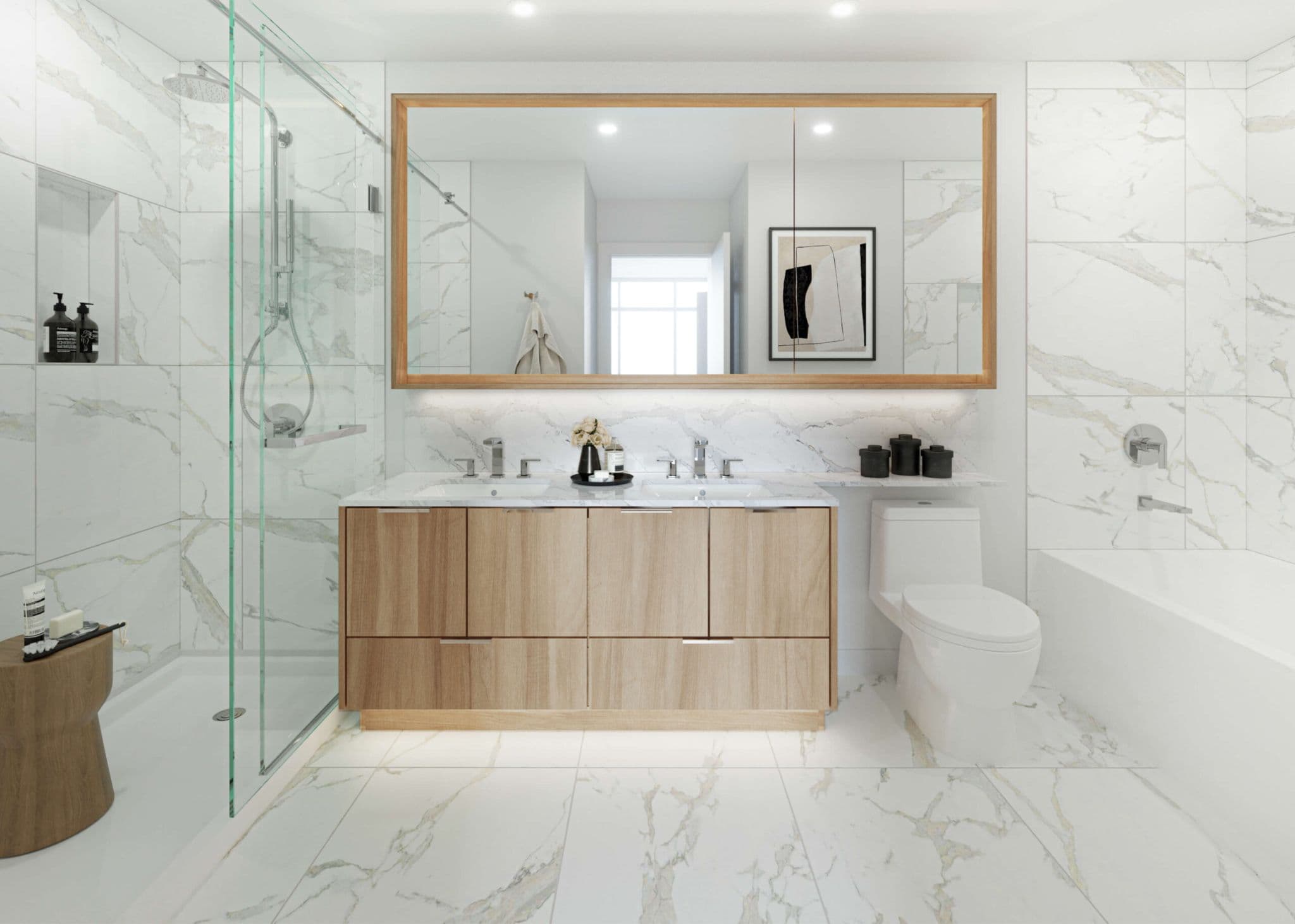 Icon at Southgate City – A bright, modern bathroom clad in white marble tile with warm veining covering the floors and shower walls. A light wood double vanity with an illuminated wood-framed mirror serves as the centerpiece, flanked by a glass-enclosed walk-in shower on the left and a toilet and soaking tub on the right.