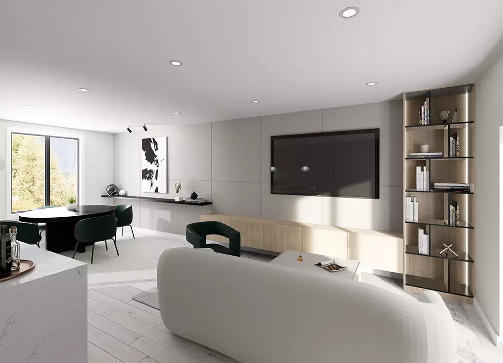 Uptown Cedar – A modern open-concept living and dining area featuring a light-toned curved sofa facing a wall-mounted TV with a low light-wood media console and built-in illuminated shelving. Adjoining the space is a dining setup with dark green upholstered chairs and a window letting in bright natural daylight.