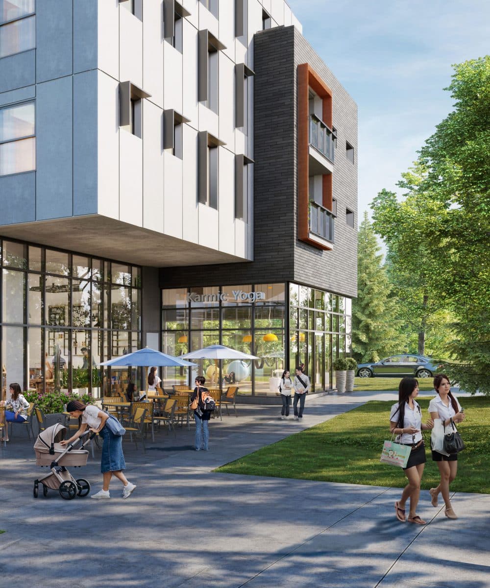 Pure West 49 – Street-level exterior of a mixed-use building with ground-floor retail including a yoga studio and outdoor cafe seating.