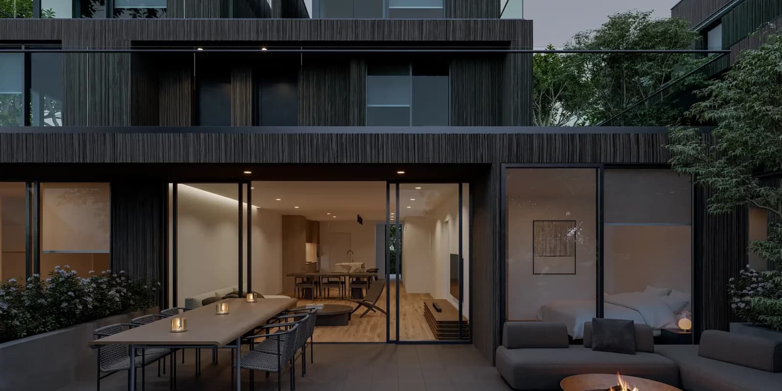 Ash 28 Condos – Rendering of a ground-floor patio at night with an outdoor dining table, fire pit lounge area, and glass doors opening into a lit interior.