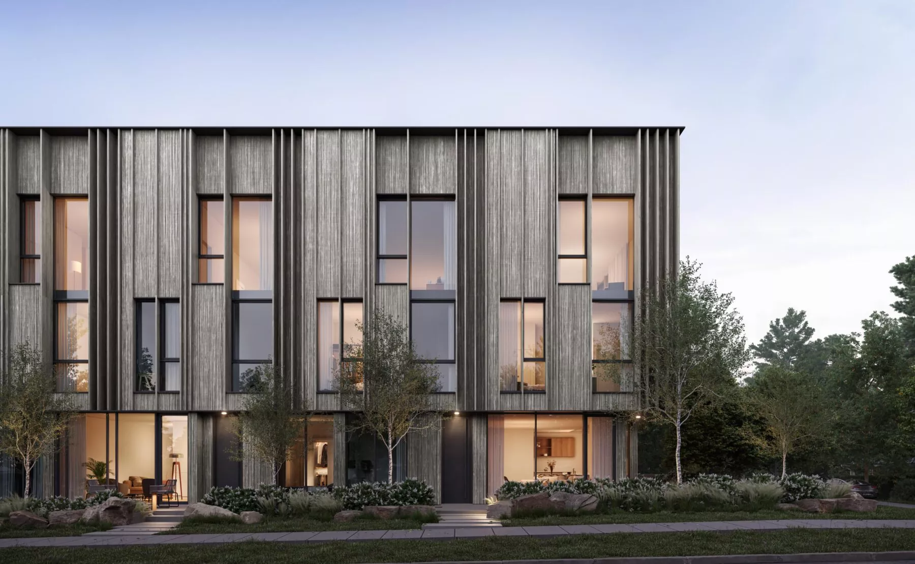 Ash 28 Condos – Rendering of a modern building with vertical wood-slat cladding, large windows, and landscaped front yard at dusk, lit from within.
