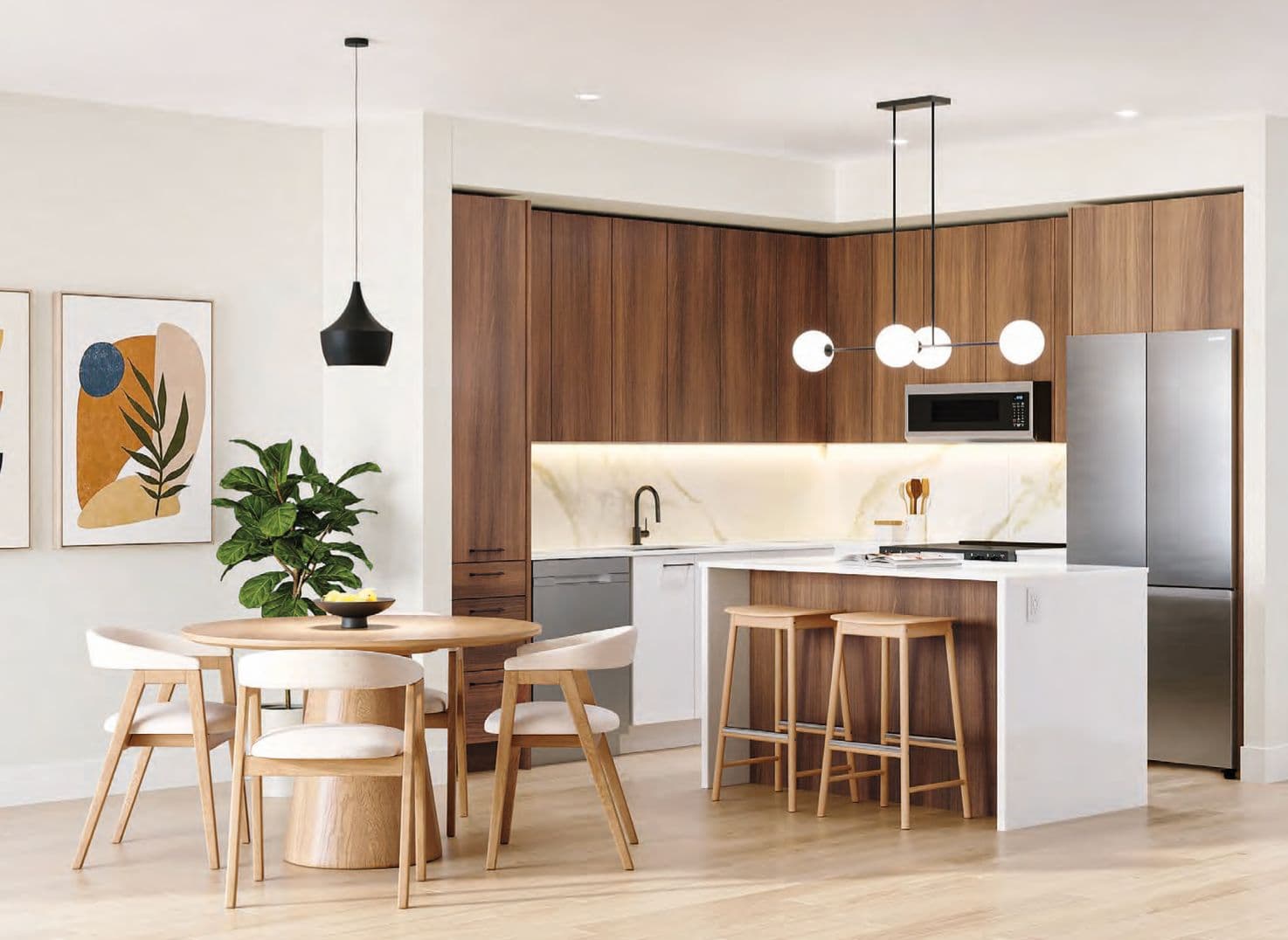 Aria 2 – Dining and kitchen area with a round wood table, cream chairs, pendant lighting, and a stainless steel refrigerator.