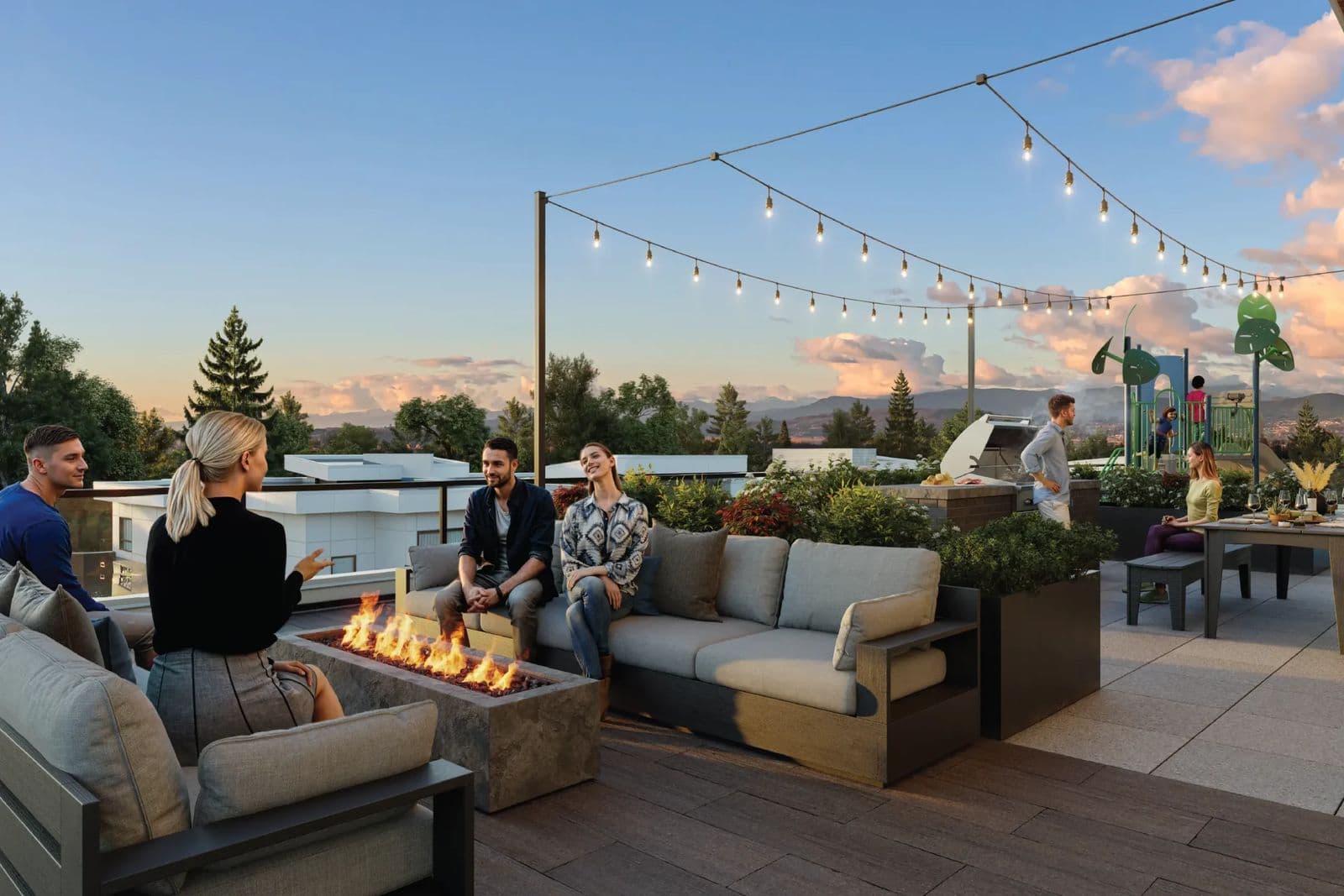 Triumph – Rendering of a rooftop lounge at dusk with a fire pit, outdoor sofas, string lights, a BBQ station, and a children's play structure in the background.