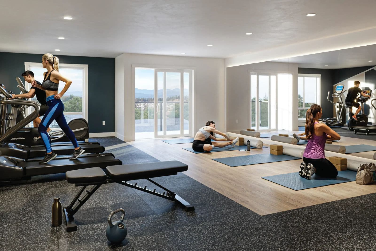 Triumph – Rendering of a fitness studio with treadmills, an exercise bike, a weight bench, and a stretching area with yoga mats, overlooking mountains through large windows.