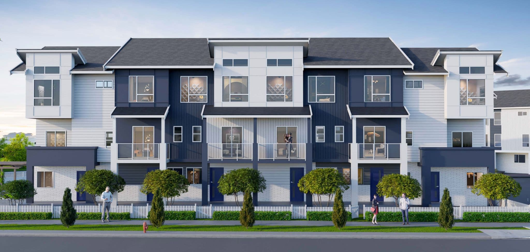 Fiore – A row of two-story townhomes with navy and white paneling, wood-trimmed gable dormers, and orange front doors, along a street with pedestrians and young trees.