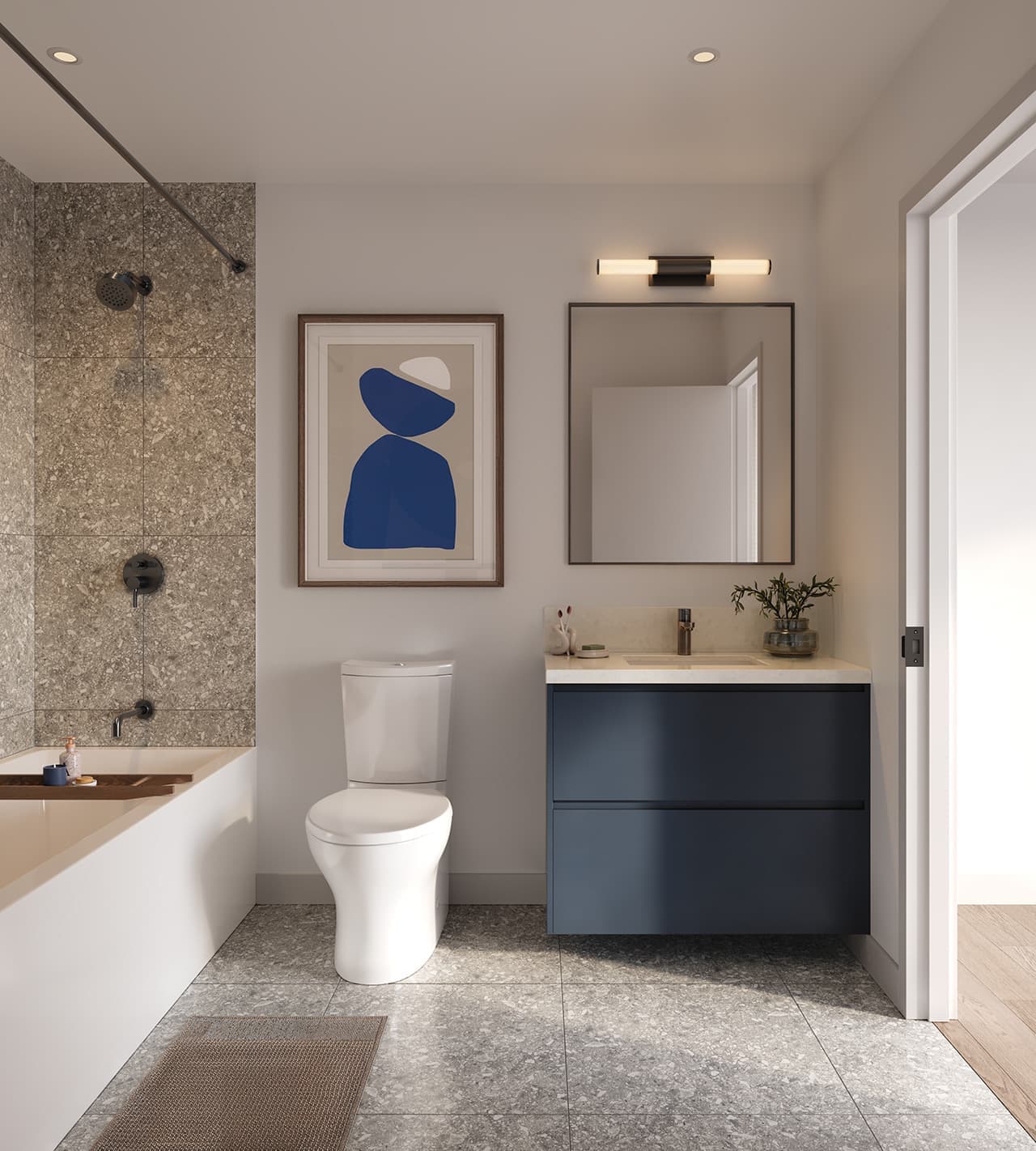 Matteō – Bathroom with a stone-tiled tub/shower, a blue abstract print, and a navy floating vanity with a light stone countertop.