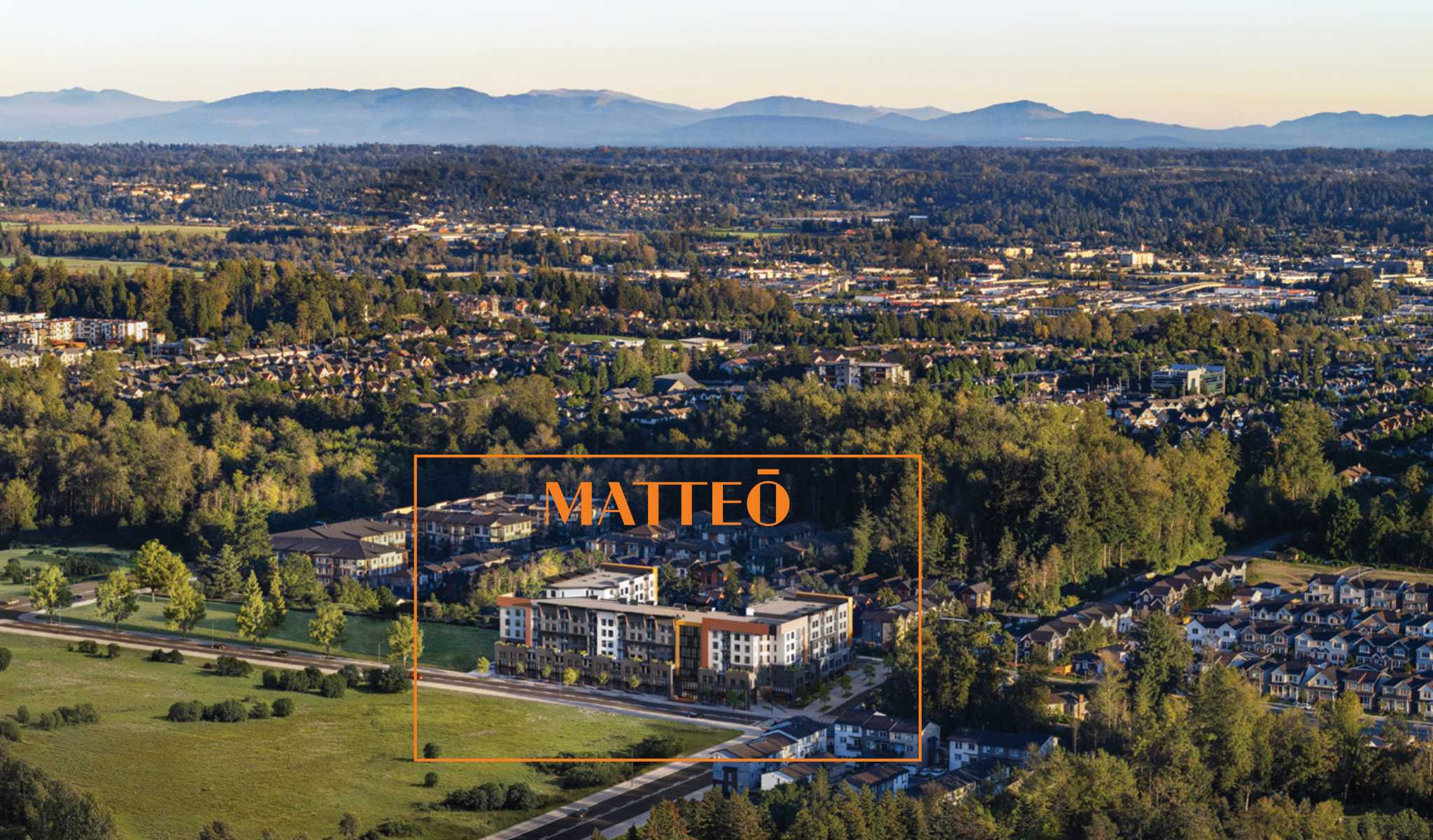 Matteō – Aerial photo of a suburban valley with mountains in the distance, with an orange box and 'MATTEO' label highlighting the mid-rise development site among surrounding neighborhoods.