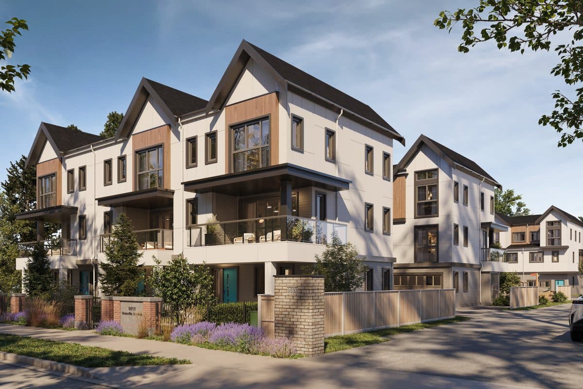 Infinity Garden – A ground-level rendering of a modern three-story townhouse community featuring gabled roofs, light siding, warm wood accents, and upper-level balconies. The foreground showcases a paved drive, low brick wall pillars, wooden fencing, and manicured landscaping with lavender under a clear daytime sky.