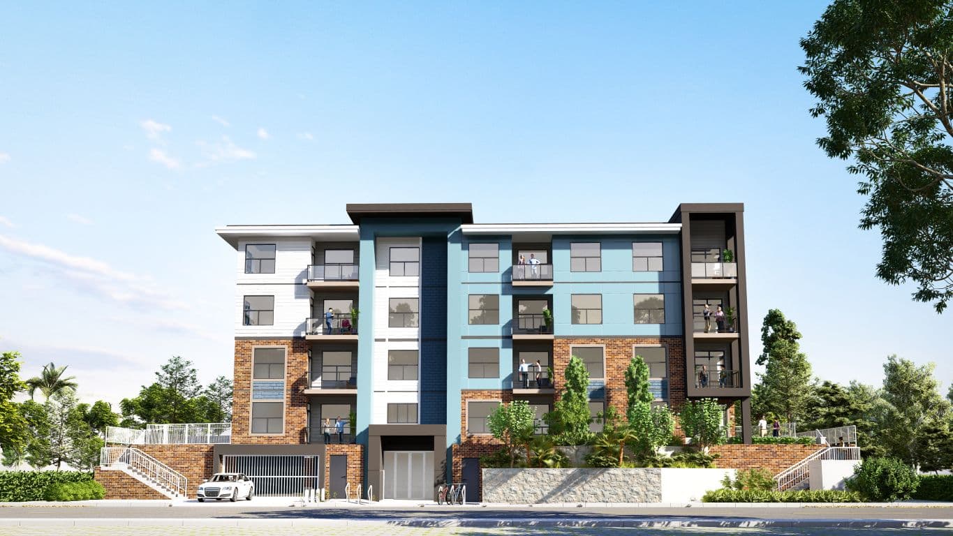 Sakoon Living – A street-level architectural rendering shows a modern four-story residential building featuring a mix of red brick cladding, teal and white facade panels, and glass-railed balconies with people on them. Ground-level features include an underground parking entry with a white car, neatly landscaped stone retaining walls, and small trees under a bright daytime sky.