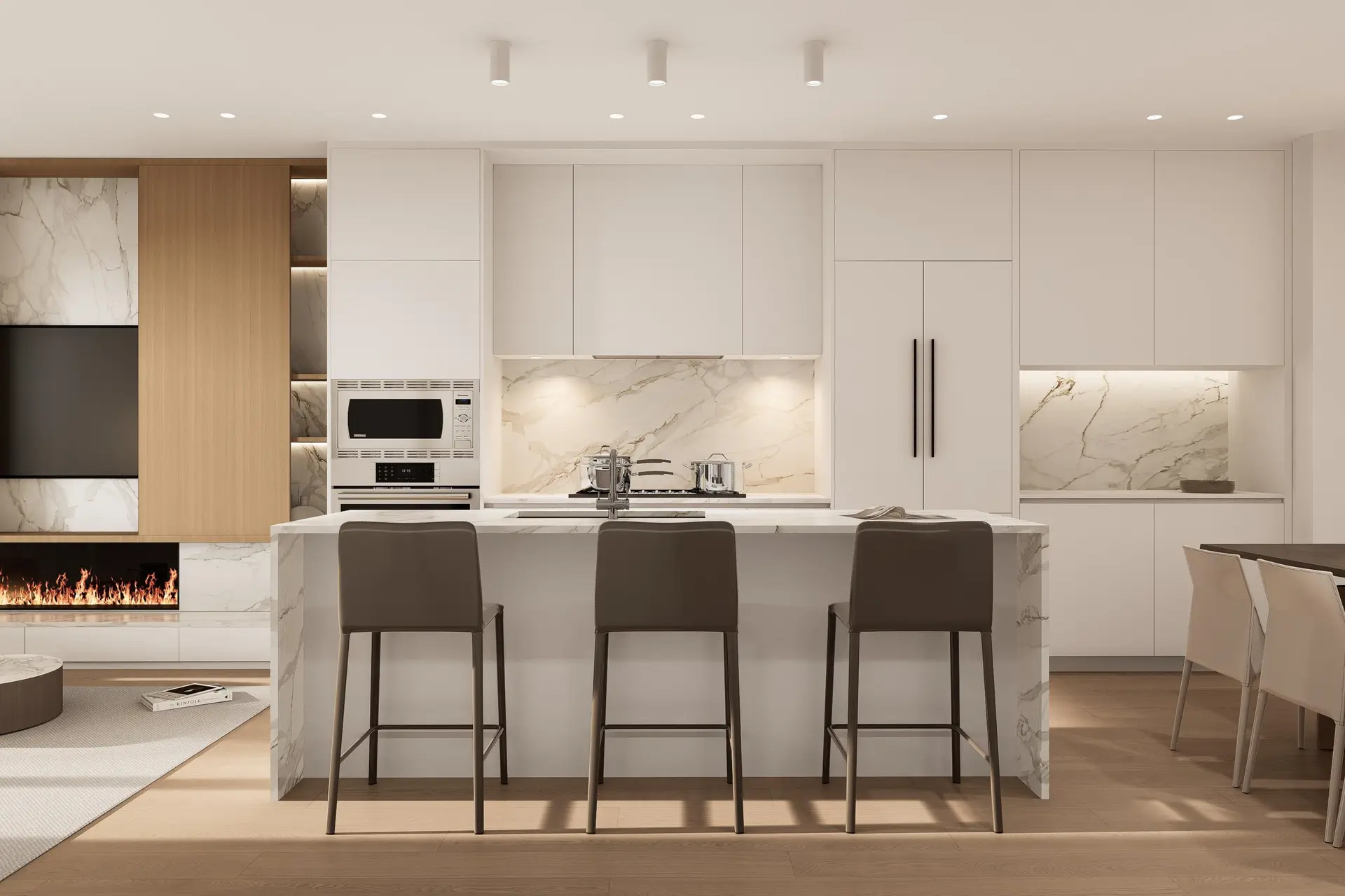 Holland Row II – An open kitchen and living area with white cabinetry, a marble backsplash, an island with bar stools, and a built-in fireplace.