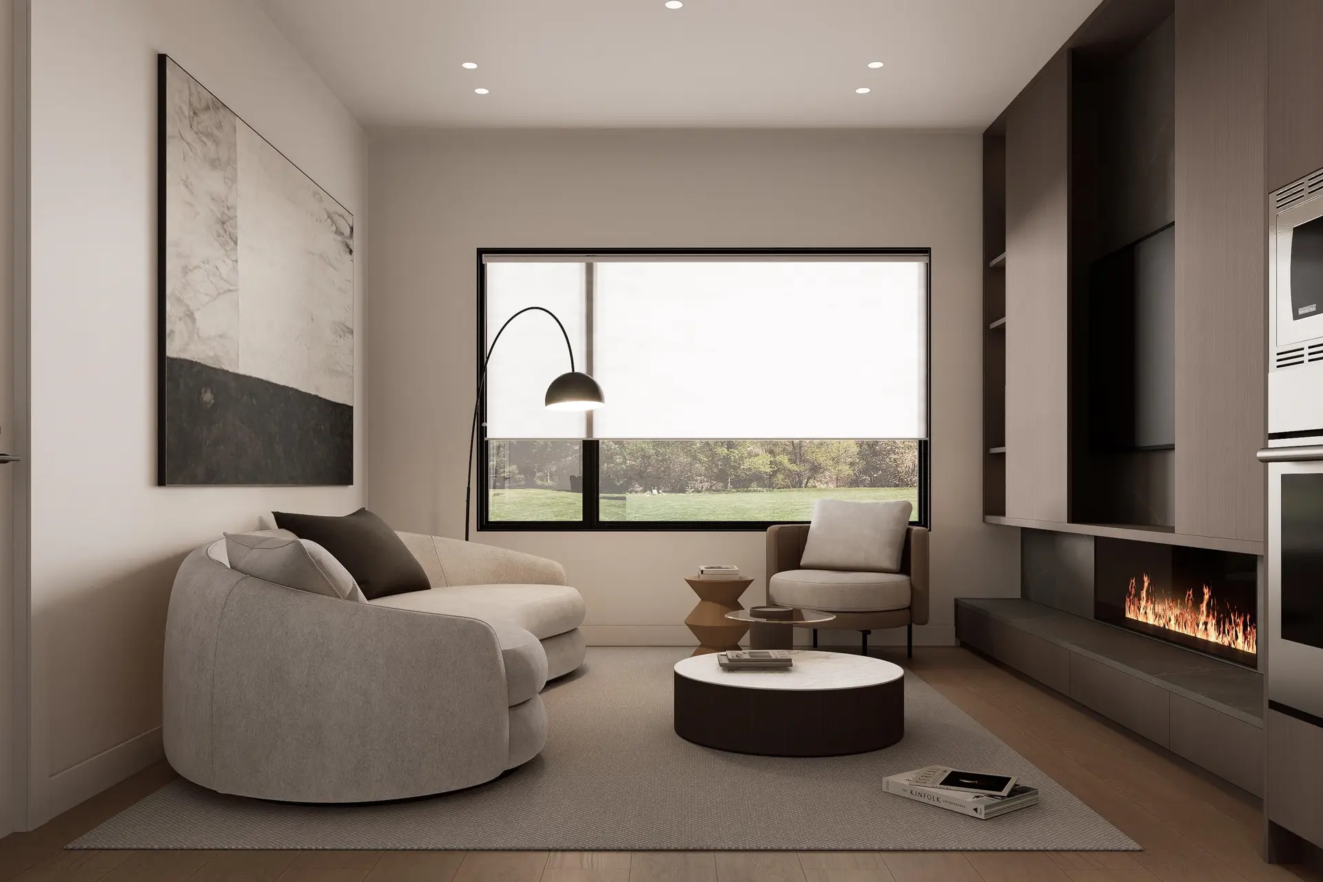 Holland Row II – A living room with a grey curved sofa, round coffee tables, an arc floor lamp, and a built-in gas fireplace beside a wall-mounted TV.