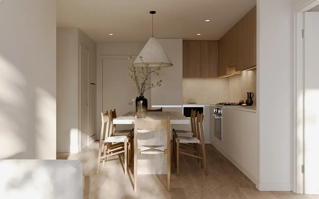 Söenhaus – Kitchen and dining area with light grey lower cabinets, wood upper cabinets, gas cooktop, and a stone dining table with wishbone-style chairs under a cone pendant light.