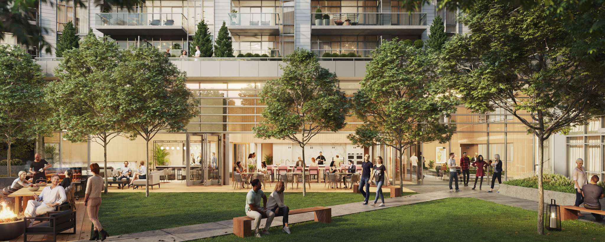 RC at CF Richmond Centre – A bustling outdoor amenity courtyard features lush green lawns, mature shade trees, a fire pit seating area, and a barbecue zone where people are socializing. Large glass doors open into an indoor lounge space, all set against the lower floors and upper balconies of a modern residential building in warm, late-afternoon sunlight.