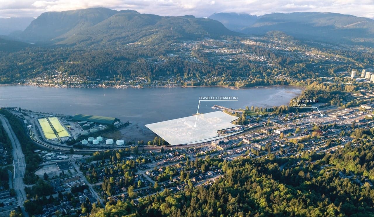 Flavelle OceanFront – Aerial drone photo of an inlet with mountains behind, with the future Flavelle Oceanfront site and nearby Moody Centre transit station labeled on the shoreline.