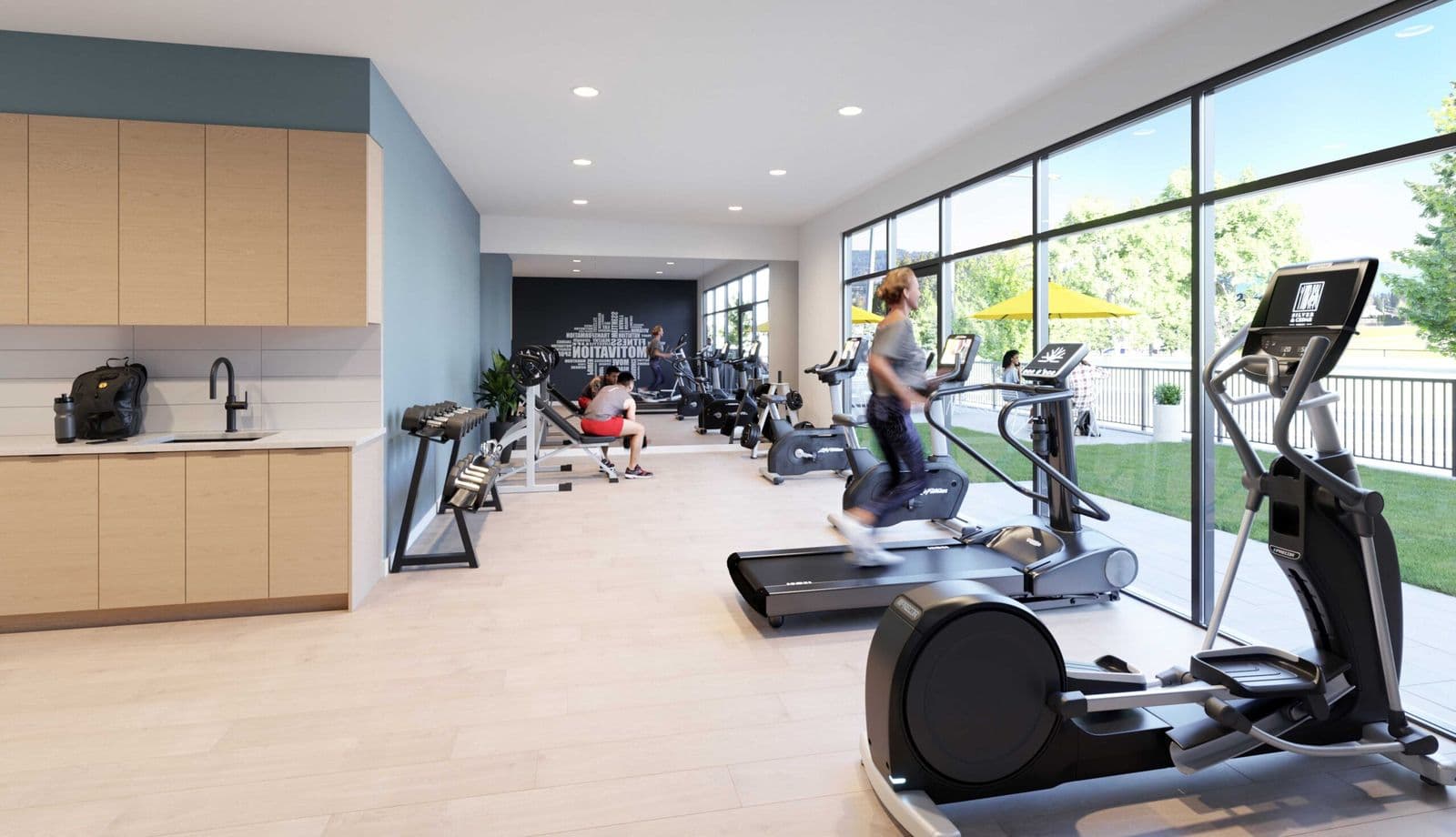 Silver & Cedar – Rendering of a fitness room with treadmills, ellipticals, and weight equipment beside a kitchenette, with floor-to-ceiling windows opening onto an outdoor patio with yellow umbrellas.