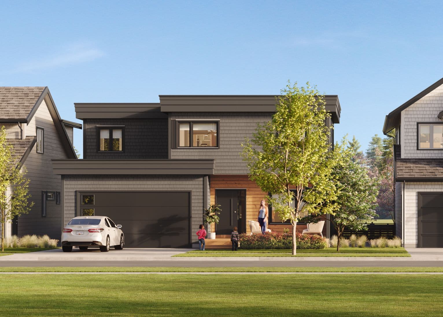 Boardwalk 7 – A contemporary two-storey single-family home featuring grey cedar shake siding, dark trim, and warm wood accents around the front porch entry. A white car is parked in the paved driveway beneath bright daylight, with a landscaped front yard and people visible by the entrance.