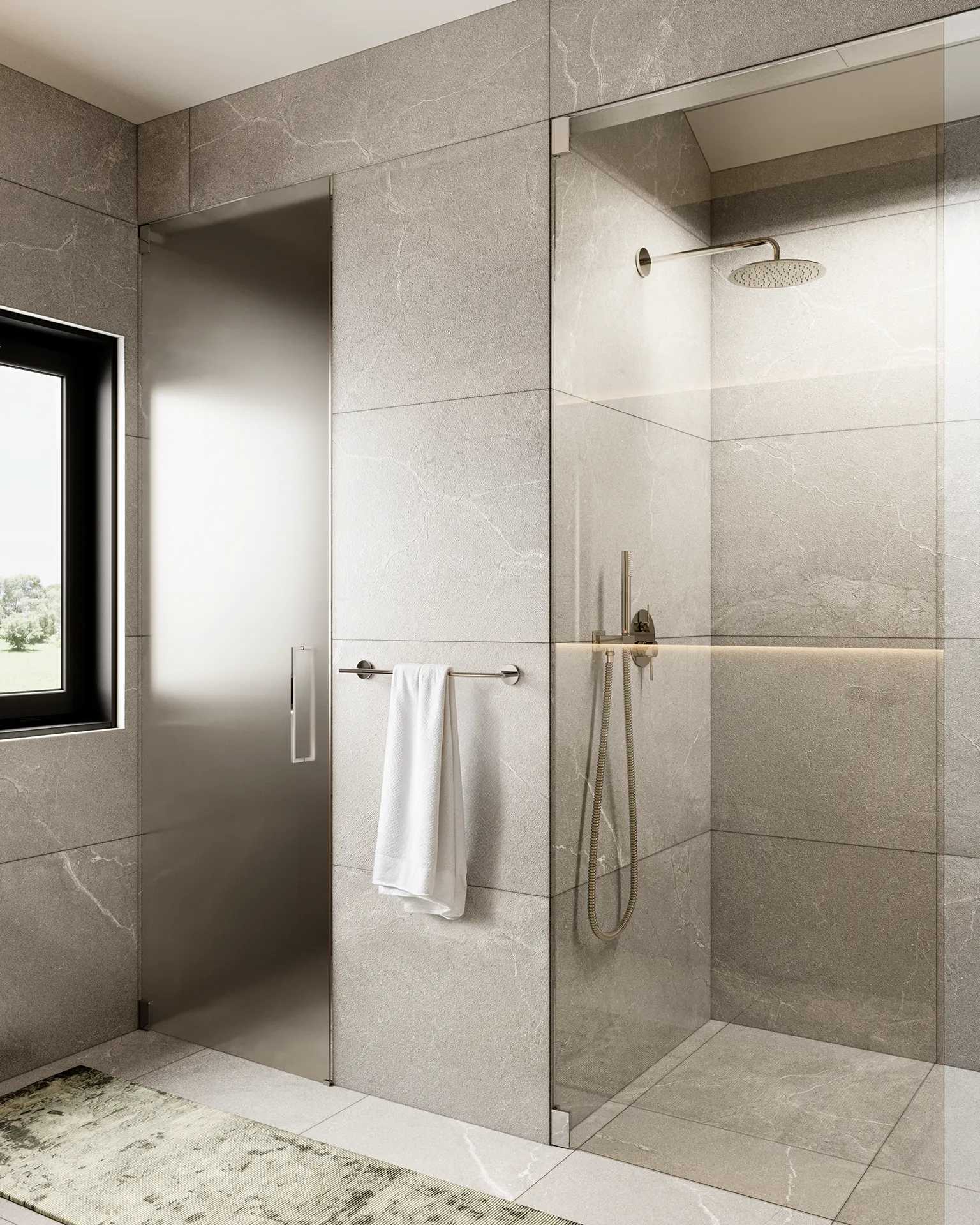 Ansoku – Bathroom with a frameless glass shower enclosure, grey stone-look tile, rainfall shower head, and a hanging white towel.