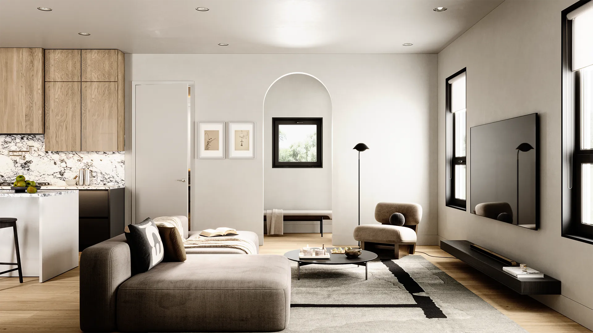Ansoku – Living room with a grey sectional, wall-mounted TV, floor lamp, and an arched doorway leading to a window nook beyond.