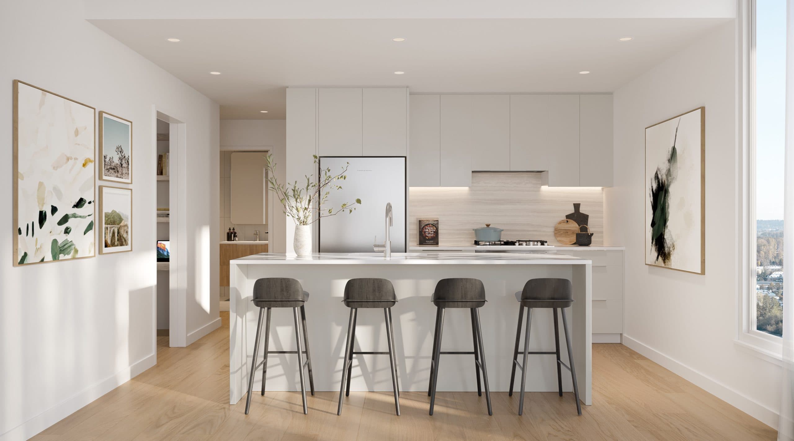 Encore – A bright, modern kitchen features a large white waterfall island with four dark wood barstools, set against light oak flooring. The background showcases minimalist white cabinetry, integrated stainless steel appliances, and soft under-cabinet lighting, creating a warm and clean aesthetic.