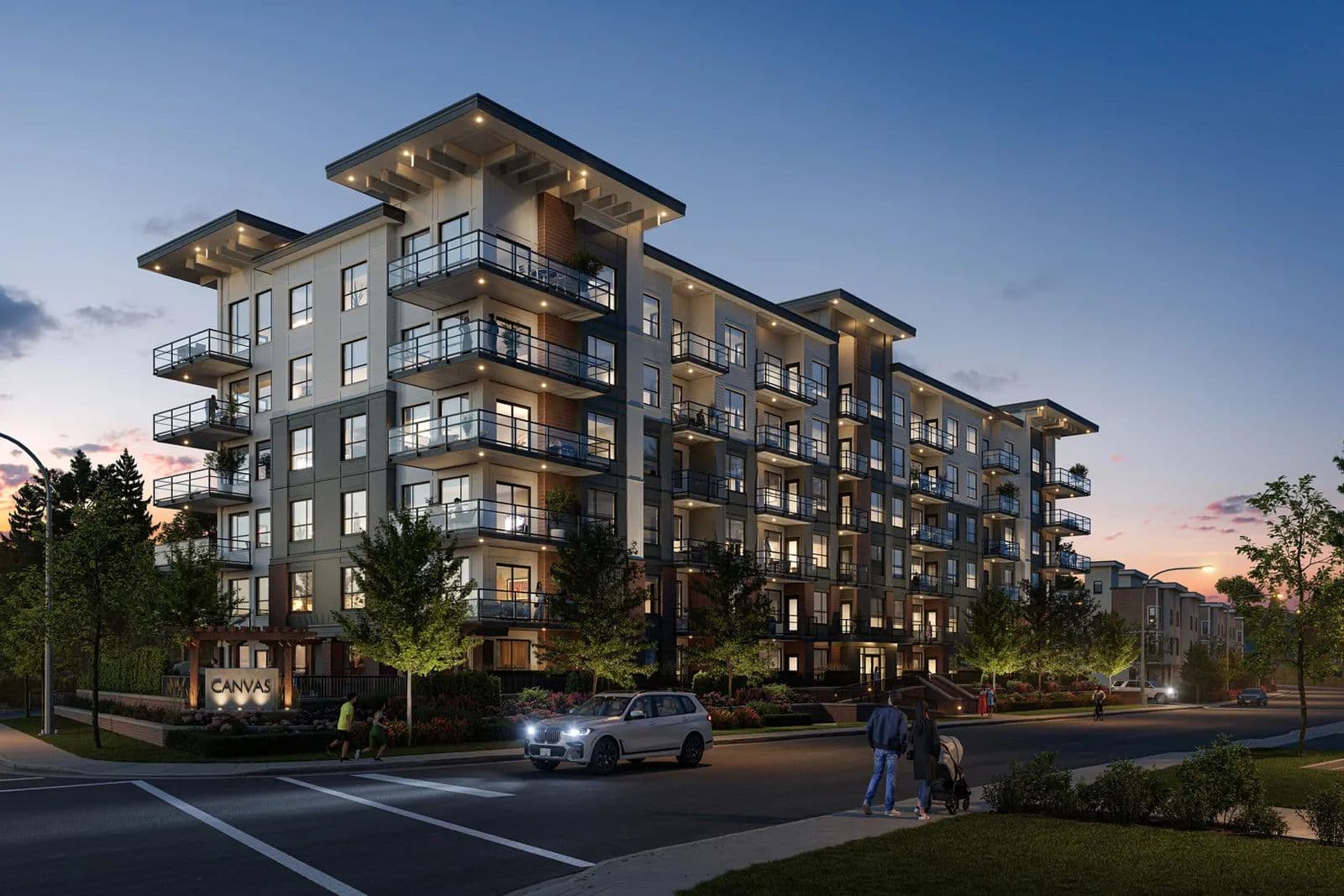 Canvas – Street corner view at dusk of a multi-story condo building with cream and dark paneled facade, a Canvas monument sign, and pedestrians on the sidewalk.