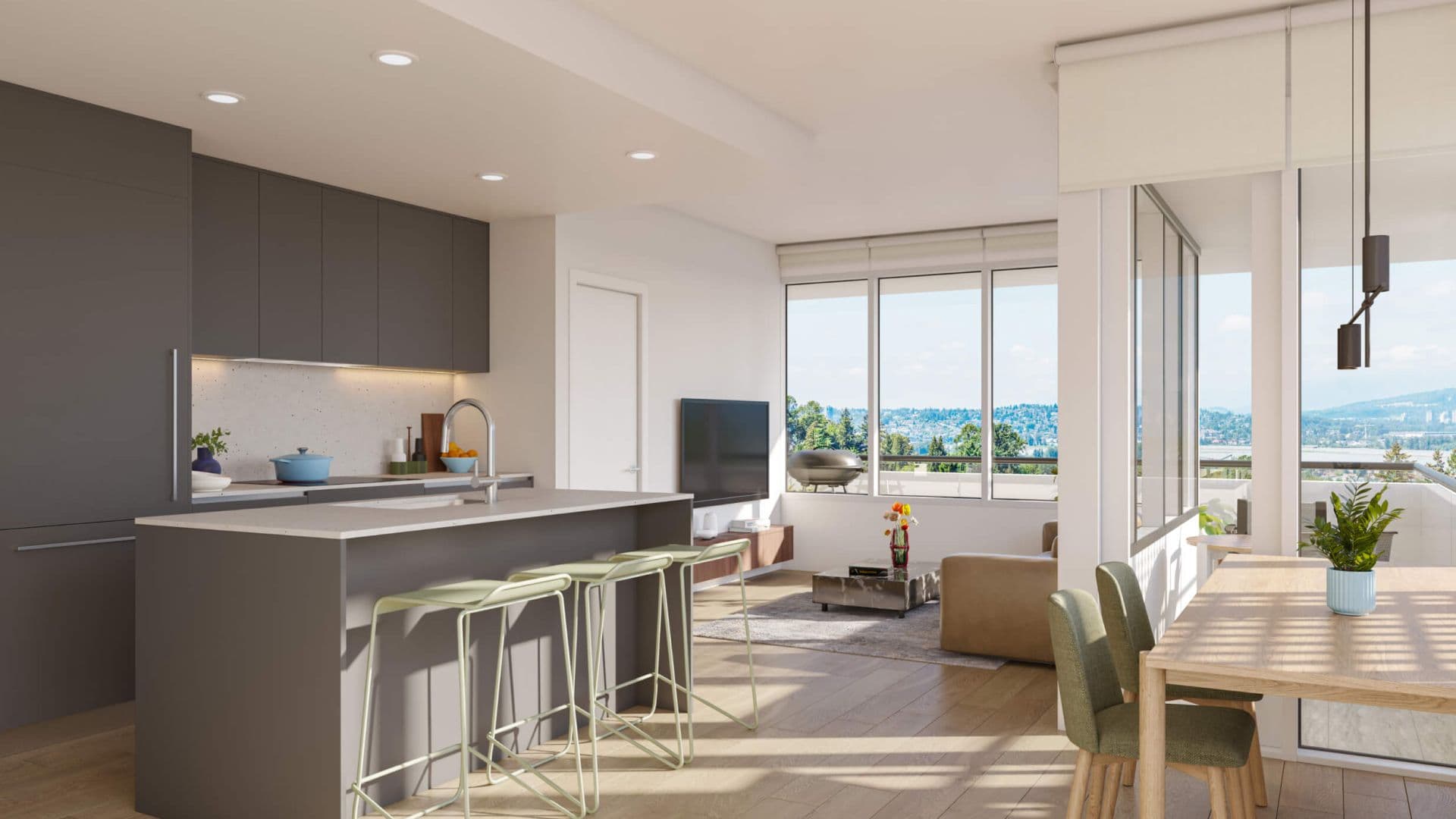 BridgeCity – A modern open-concept kitchen and living area featuring dark gray flat-panel cabinetry, a quartz island with light green barstools, and light wood flooring illuminated by bright daylight. Large windows and glass sliding doors reveal a sunny balcony with outdoor furniture overlooking a scenic view of green hills and distant water.
