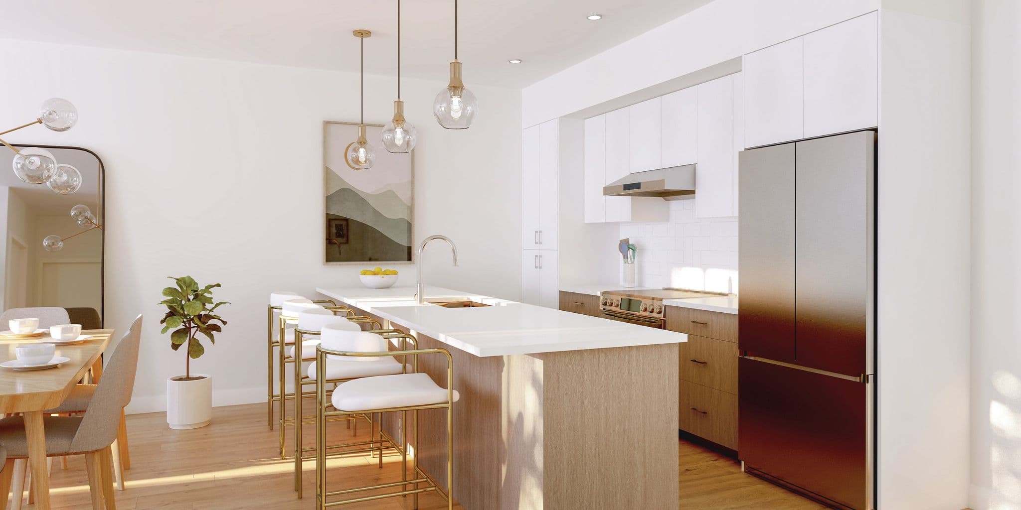 Ravir – Open-concept kitchen and dining area with a large island, gold pendant lighting, and stainless-steel fridge, opening onto a dining table.
