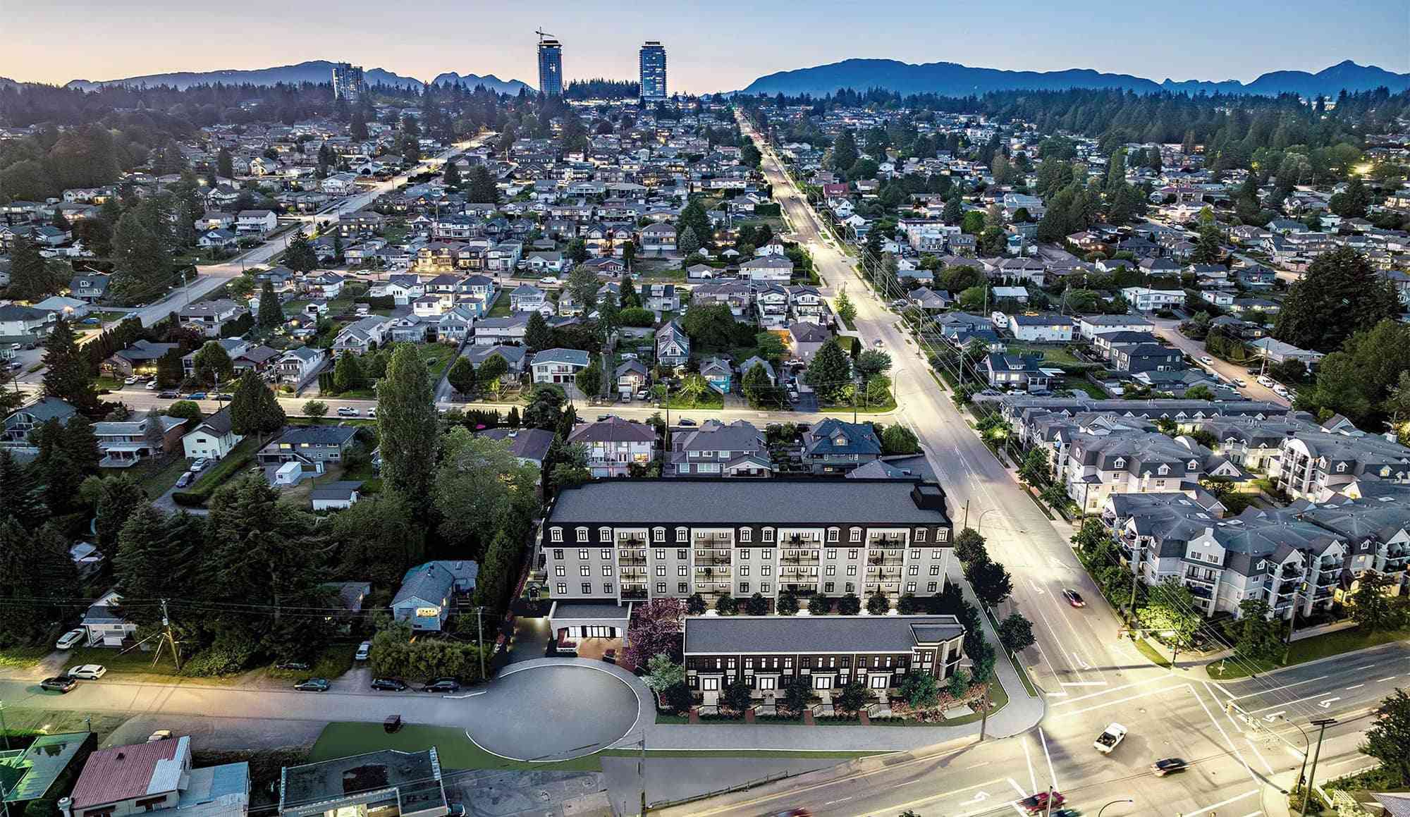 Ravir – Dusk aerial view of the building set among surrounding houses, with the city and mountains in the background.