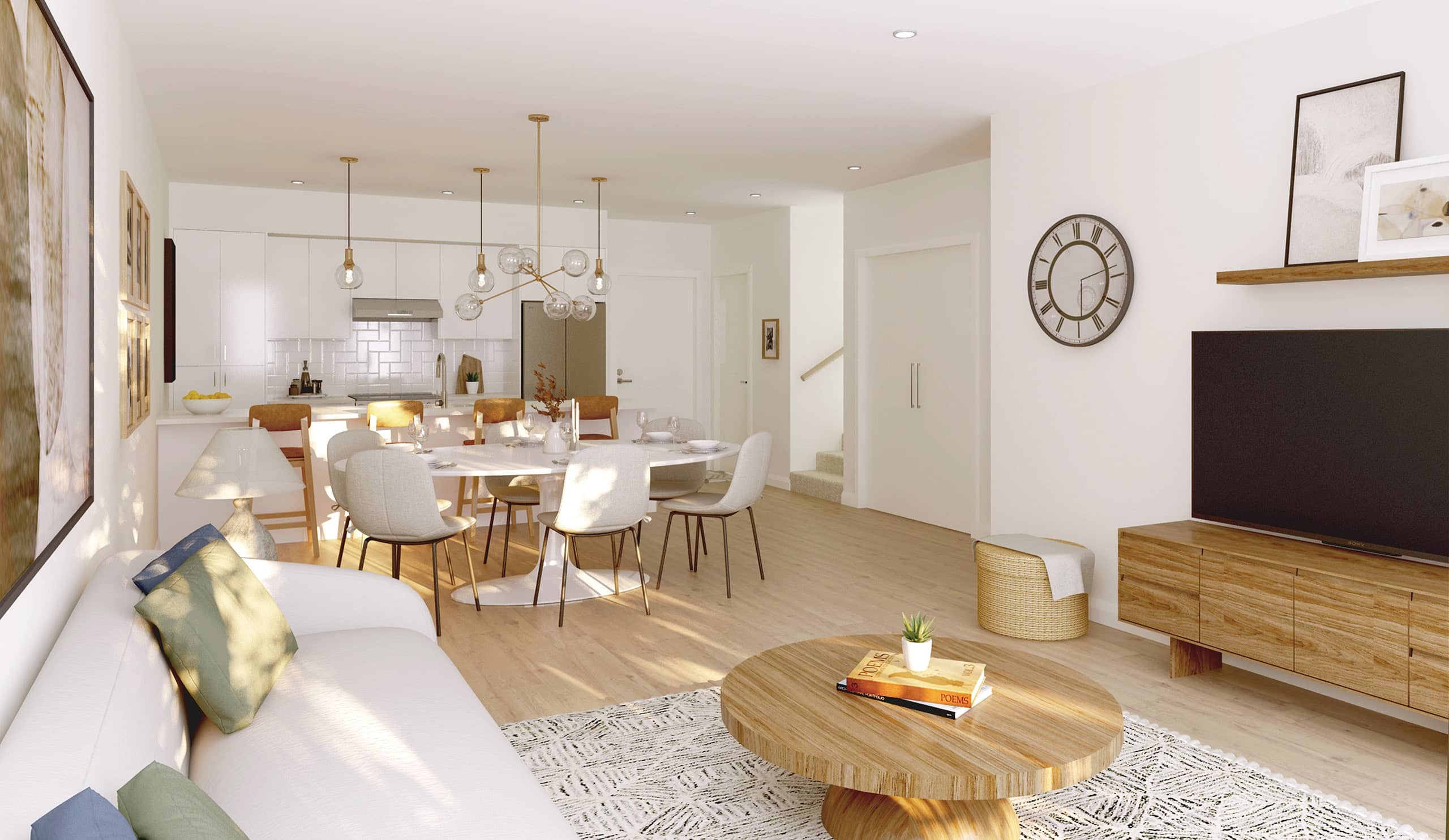 Ravir – Open dining and living room with a round wood table, upholstered chairs, a wall clock, and a mounted TV on a wood console.